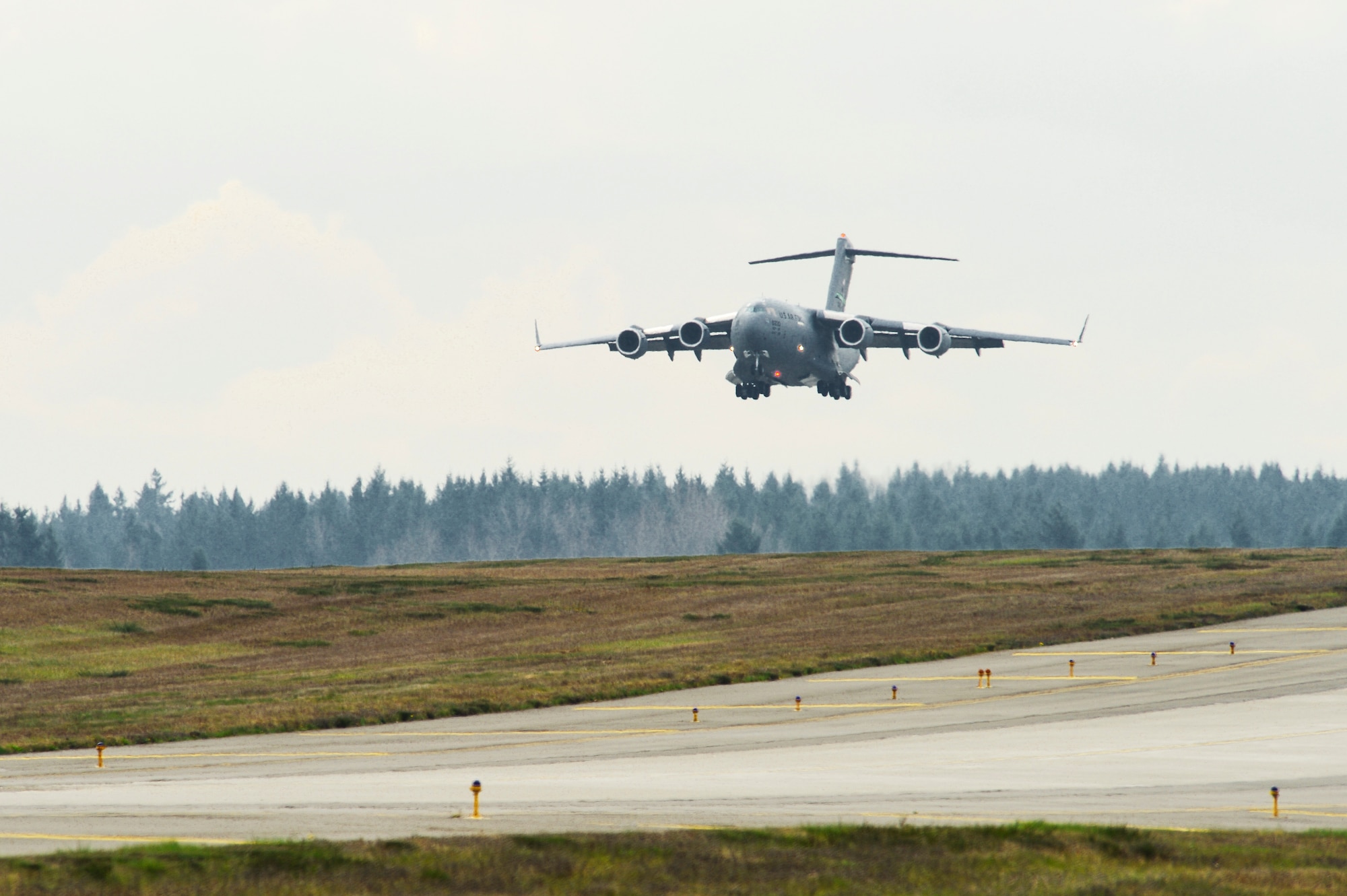 A C-17 Globemaster III makes its descent in preparation for its initial touchdown at its new home, March 27, 2013, at Joint Base Lewis-McChord, Wash. The aircraft is the final new C-17 to be delivered to McChord Field. (U.S. Air Force photo/Tech. Sgt. Sean Tobin)