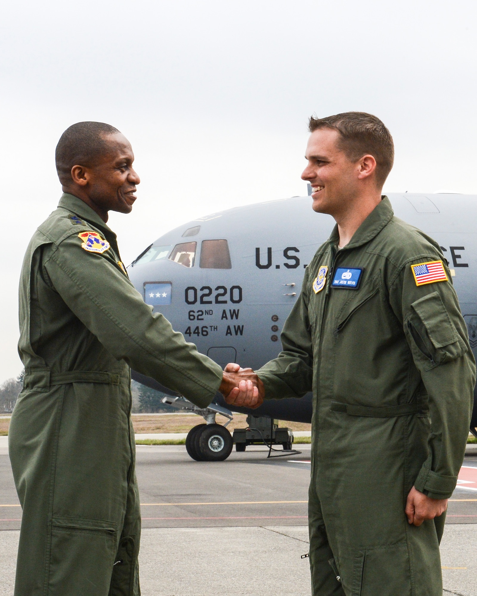 Lt. Gen. Darren McDew, 18th Air Force commander (left), passes the "keys" of McChord Field's newest and final C-17 Globemaster III, to Tech. Sgt. Justin Reeves, 62nd Aircraft Maintenance Squadron flying crew chief, during a ceremony March 27, 2013, at Joint Base Lewis-McChord, Wash. The ceremony took place shortly after the aircraft's initial touchdown at its new base, and was a celebration of the C-17’s 14-year history at McChord Field. (U.S. Air Force photo/Staff Sgt. Jason Truskowski)