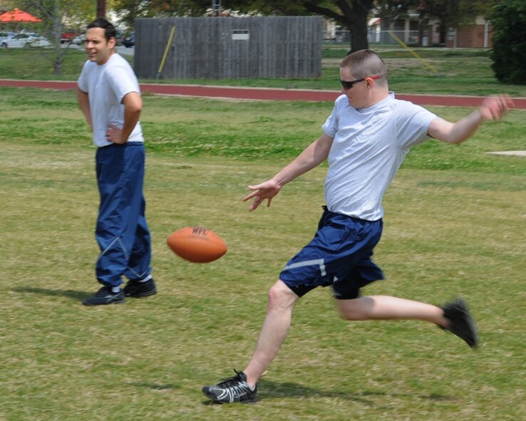 Senior Airman Dustin Rottinghaus, 26th Operational Weather Squadron, kicks a ball during a game of ultimate football at the Bryan Bell Fitness Center on Barksdale Air Force Base, La., March 29. The fitness center is open Monday through Friday from 4 a.m. to 12 a.m. and Saturday through Sunday from 8 a.m. to 6 p.m. (U.S. Air Force photo/Senior Airman Sean Martin)