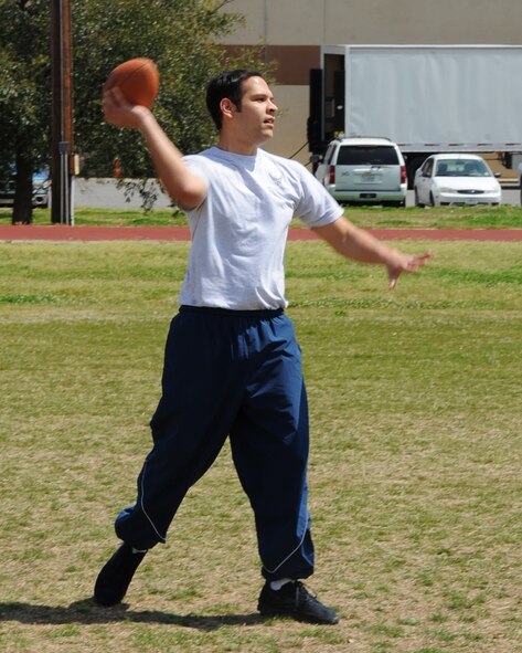 Airman 1st Class Gui Lopez-Avila, 26th Operational Weather Squadron weather forecaster, throws a football at the Bryan Bell Fitness Center on Barksdale Air Force Base, La., March 29. The fitness center has an indoor and outdoor running track, a cardio and weight room, and basketball and racquetball courts available to Barksdale personnel. (U.S. Air Force photo/Senior Airman Sean Martin)