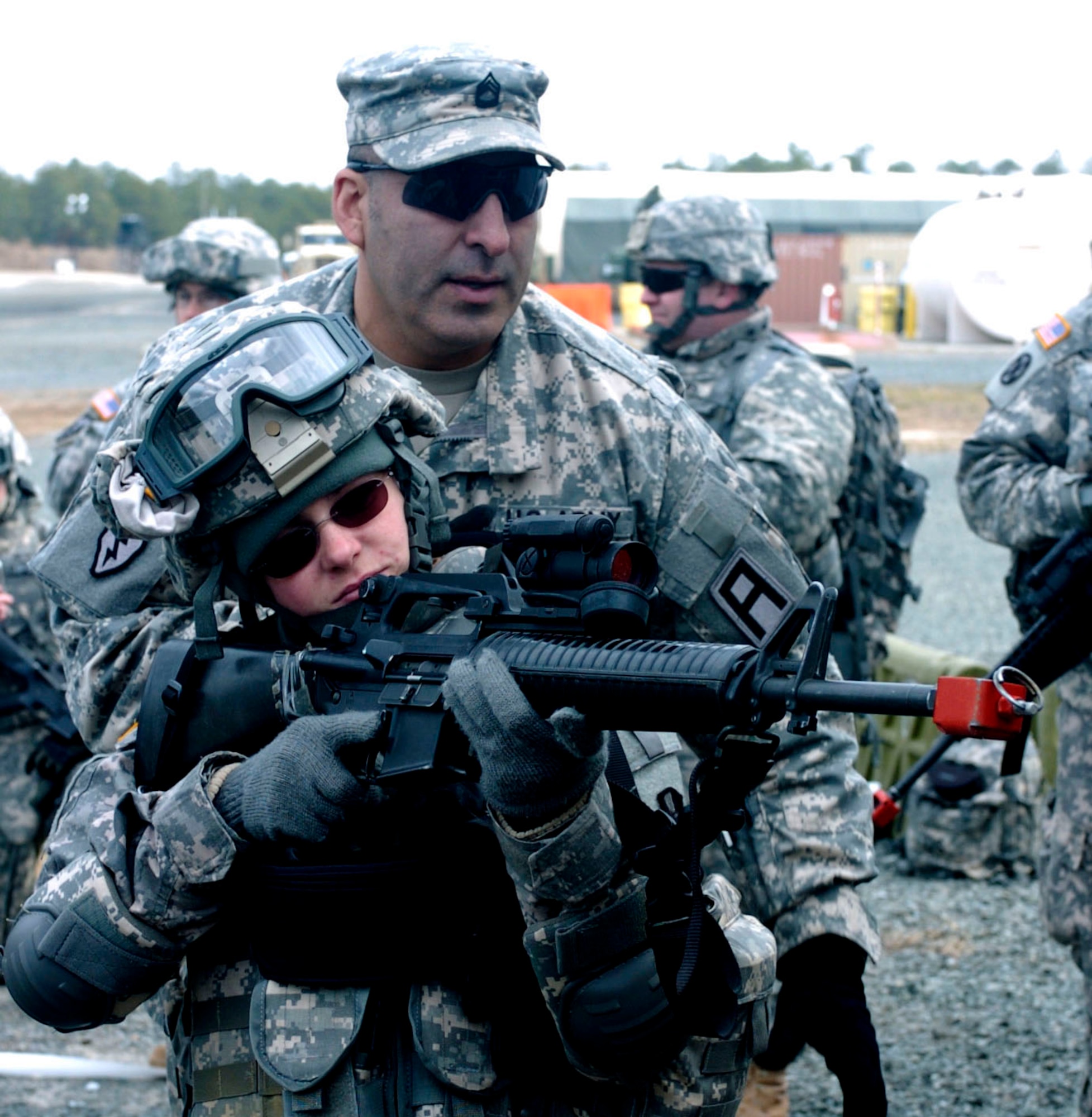 Sgt. 1st Class Daniel Garcia of 1st Battalion, 307th Infantry Regiment trainer, trains Spc. Christina Dion, 300th Mobile Public Affairs Detachment journalist, in room-clearing tactics and procedures Dec. 12, 2009, at Joint Base McGuire-Dix-Lakehurst, N.J. Garcia is part of the 174th Infantry Brigade tasked with executing and certifying training for deploying service members. (U.S. Army photo by Staff Sgt. Donald L. Reeves/Released)