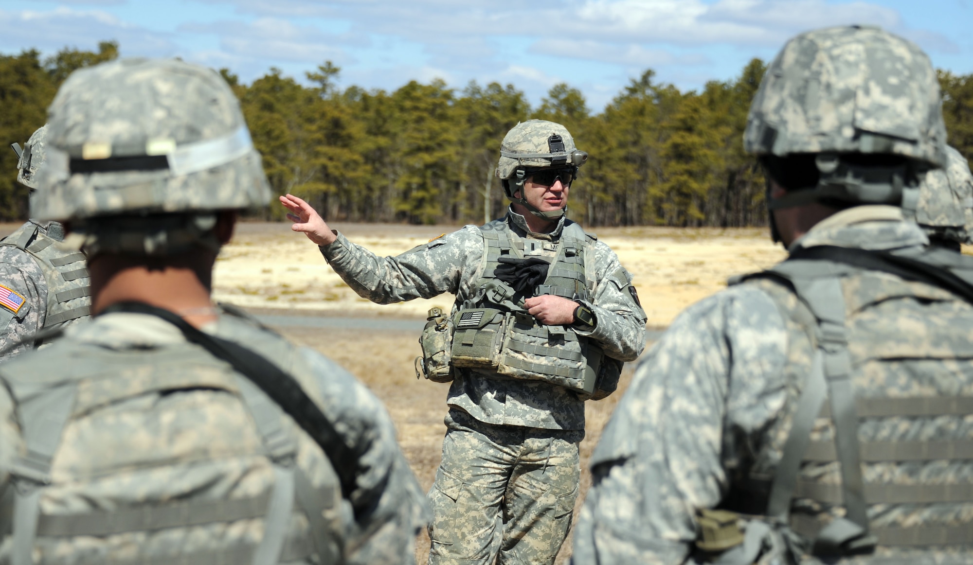 New Jersey National Guard 1st Lt. Patrick Moore, 2nd Battalion, 113th Infantry Regiment, executive officer, discusses the performance of the squad following the squad live-fire exercise on Range 61 March 23, 2013, at Joint Base McGuire-Dix-Lakehurst, N.J.  Moore, a Fanwood, N.J., native, was responsible for certifying the squad to ensure they are able to take part in company live-fire exercises. The unit is based out of Riverdale, N.J. (U.S. Air Force photo by 2nd Lt. David J. Murphy/Released)