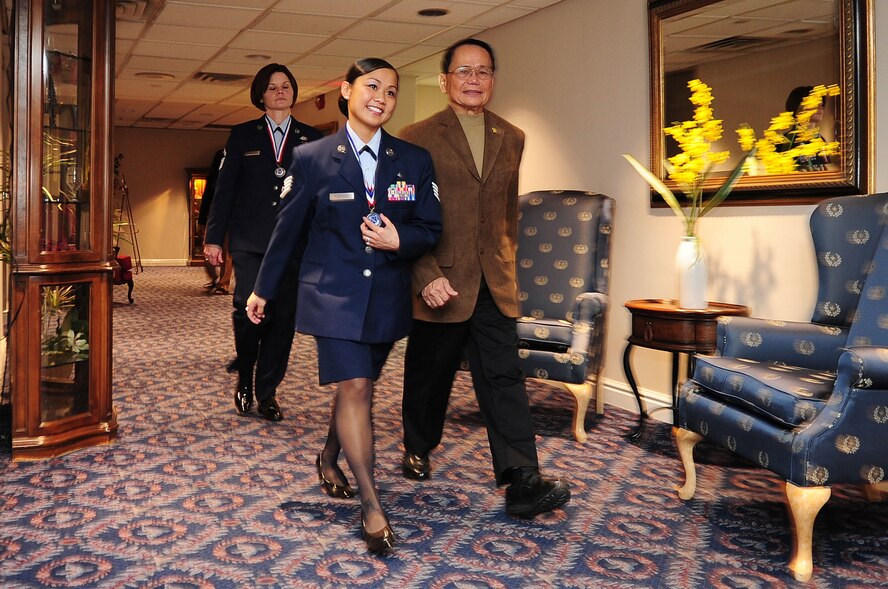 Air Force District of Washington NCO of the Year Nominee Staff Sgt. Frances Robinson, 79th Medical Wing, and her father walk to the Capital Ballroom of the Bolling Club prior to the 2012 AFDW Annual Awards Ceremony, March 22, 2013, at Joint Base Anacostia-Bolling, Washington, D.C. AFDW leadership and peers recognized military and civilian Airmen top performers for their dedication to the unit's mission of pride, teamwork and success throughout 2012. (U.S. Air Force photo by Senior Airman Steele C. G. Britton)