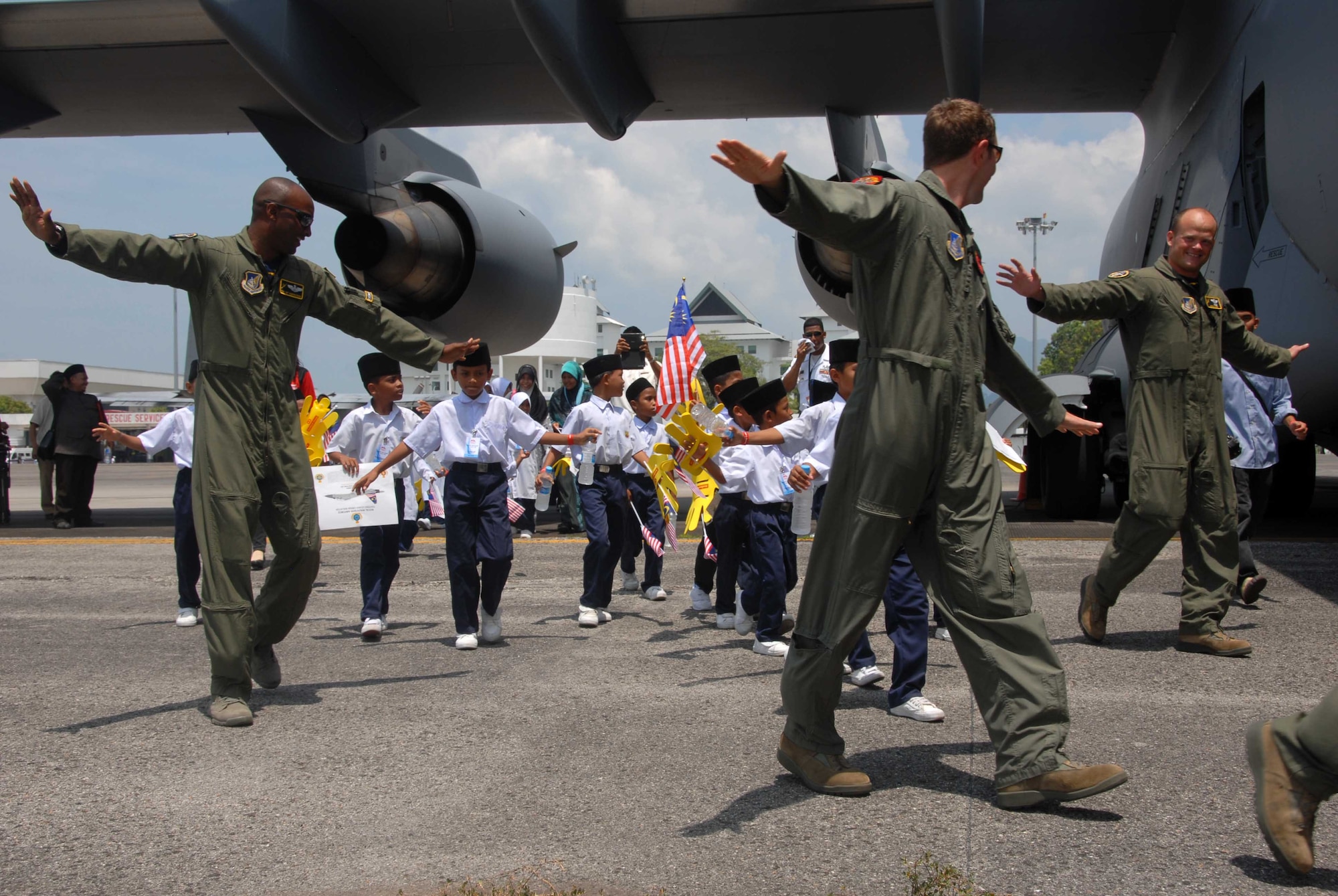 U.S. Air Force pilots of the 535th Airlift Squadron escort 50 children from the Rumah Nur Kasih Langkawi Orphanage onboard their C-17 Globemaster III for a tour during the 2013 Langkawi International Maritime and Aerospace Exhibition (LIMA 13) March 28, 2013, at Langkawi, Malaysia. LIMA 13 provides a forum to showcase U.S. assets while forming relationships that ultimately contribute to friendships and increased interoperability with militaries of other countries. (U.S. Navy photo/Mass Communication Specialist 1st Class Alfredo)  