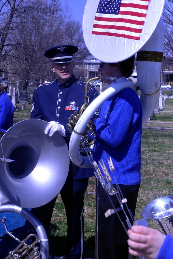 Tech. Sgt. Jess Lightner, U.S. Air Force Band member, and a member of The Wynford High School Band talk before their performance at the gravesite of composer John Philip Sousa March 23, 2013. The bands honored the composer by playing some of his most-famous marches in front of his gravesite at Congressional Cemetery in Washington, D.C. (U.S. Air Force photo/Senior Airman Lindsey A. Porter)