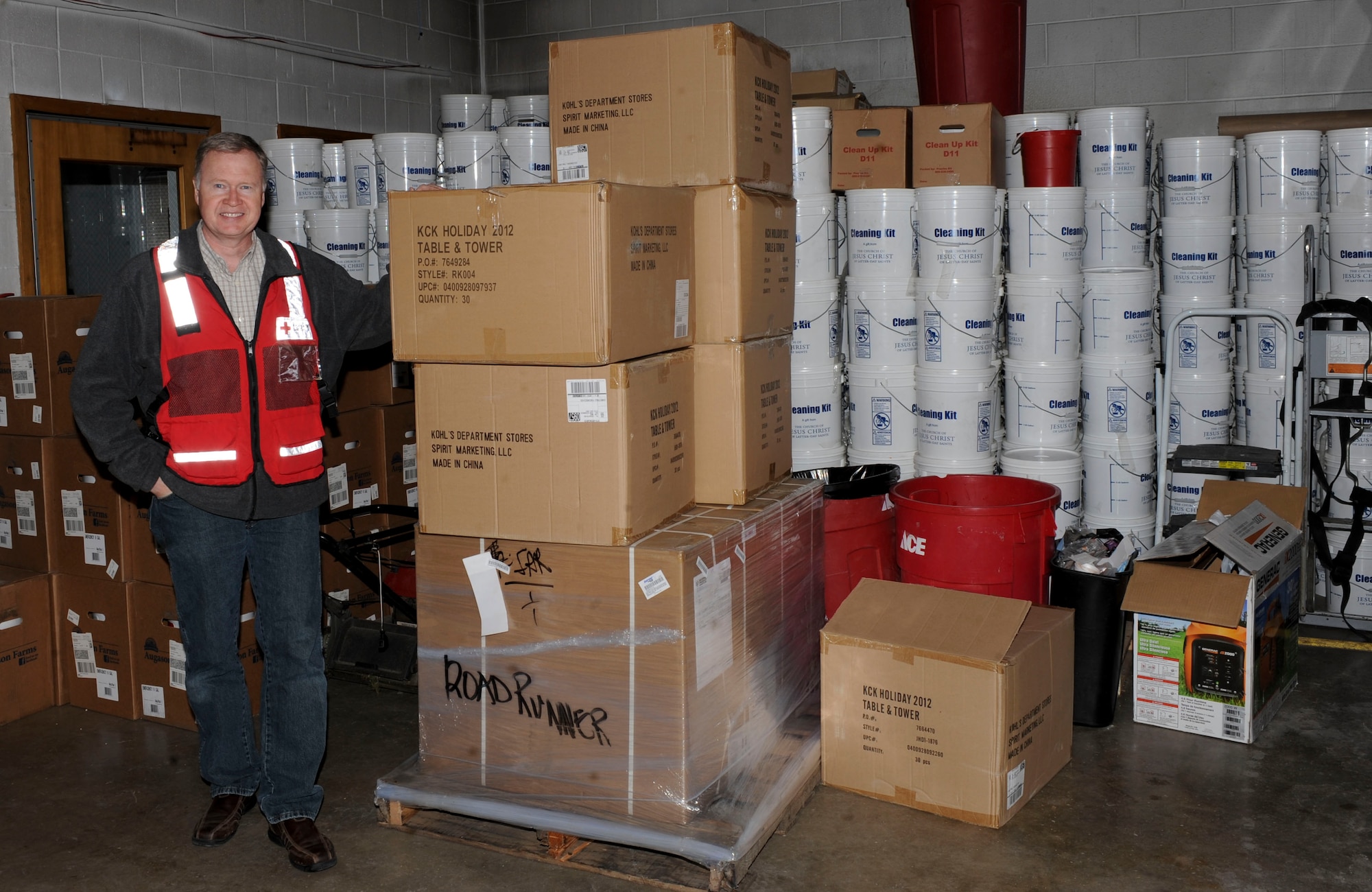 Dan Kuecker, American Red Cross Regional Emergency Services director, displays the recent supplies received for future emergencies at the Black Hills Area Chapter of the American Red Cross in Rapid City, S.D., March 22, 2013. The new supplies included a new four-wheel drive truck, electric generators, buckets of non-perishable meals, and water purification systems. (U.S. Air Force photo by Airman 1st Class Anania Tekurio/Released)