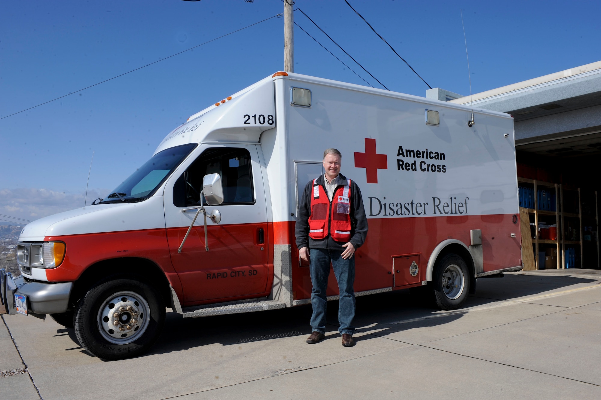 Dan Kuecker, American Red Cross Regional Emergency Services director, stands next to an emergency response vehicle in front of the Black Hills Area Chapter of the ARC in Rapid City, S.D., March 22, 2013. The Black Hills Area Chapter continually seeks volunteers to support efforts during times of crisis. (U.S. Air Force photo by Airman 1st Class Anania Tekurio/Released)