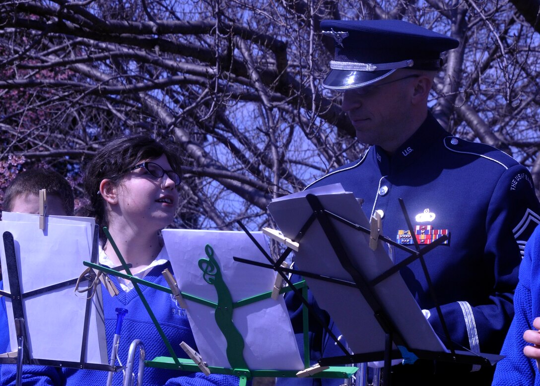 Senior Master Sgt. Michael Bosch, U.S. Air Force Band member, and a trumpet player from The Wynford High School Band pause in between selections during an afternoon performance at John Philip Sousa's gravesite in Washington, D.C. on March 23, 2013. The bands spent the afternoon honoring the composer by playing some of his most-famous marches together at his gravesite in Congressional Cemetery. (U.S. Air Force photo/Senior Airman Lindsey A. Porter)