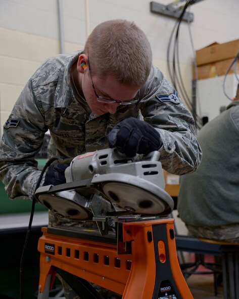 Airman First Class Matthew Incitti, 210th Engineering Installation Squadron, modifies a bracket to support radios in a rack in St. Paul, Minn., Mar., 16, 2013. Icnitti is taking time to maintain, refresh, and improve his skill level during a UTA. 
(U.S. Air Force photo by Staff Sgt. Amy M. Lovgren/Released)
