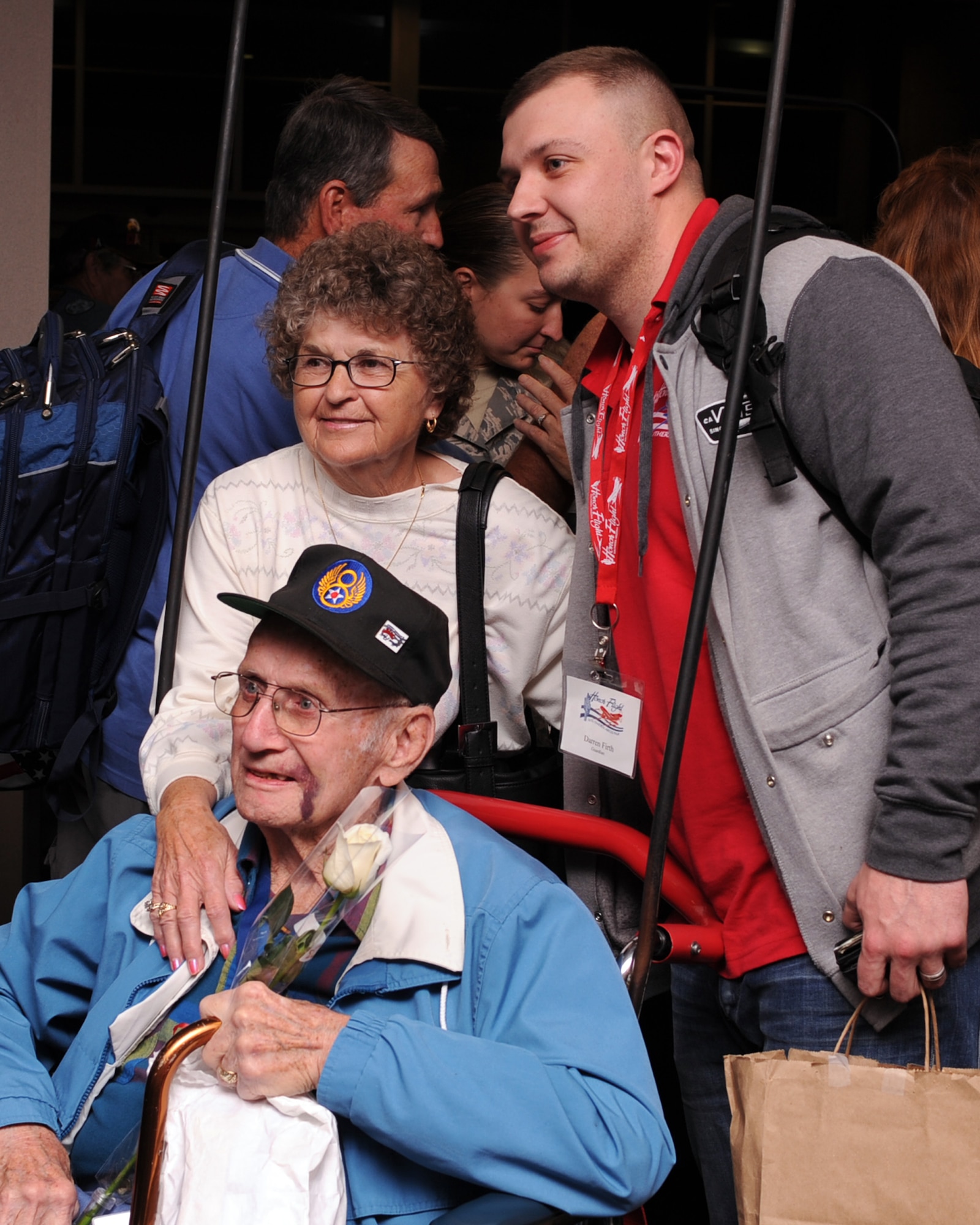 U.S. Air Force Tech. Sgt. Darren Firth, 355th Operation Support Squadron, Mr. Stephen Jones U.S. Air Force retired WWII veteran  and a family friend of 30 years pose for a photo while being welcomed home at the Tucson International Airport in Tucson, Ariz., March 28, 2013. Honor Flight Tucson is powered by volunteers who perform a plethora of duties from travel agent to travel companion. The organization sponsors war veterans on visits to Washington, D.C., where they are escorted to the commemorative memorials by their travel companions and military volunteers. (U.S. Air Force photo by Airman 1st Class Christine Griffiths/Released) 