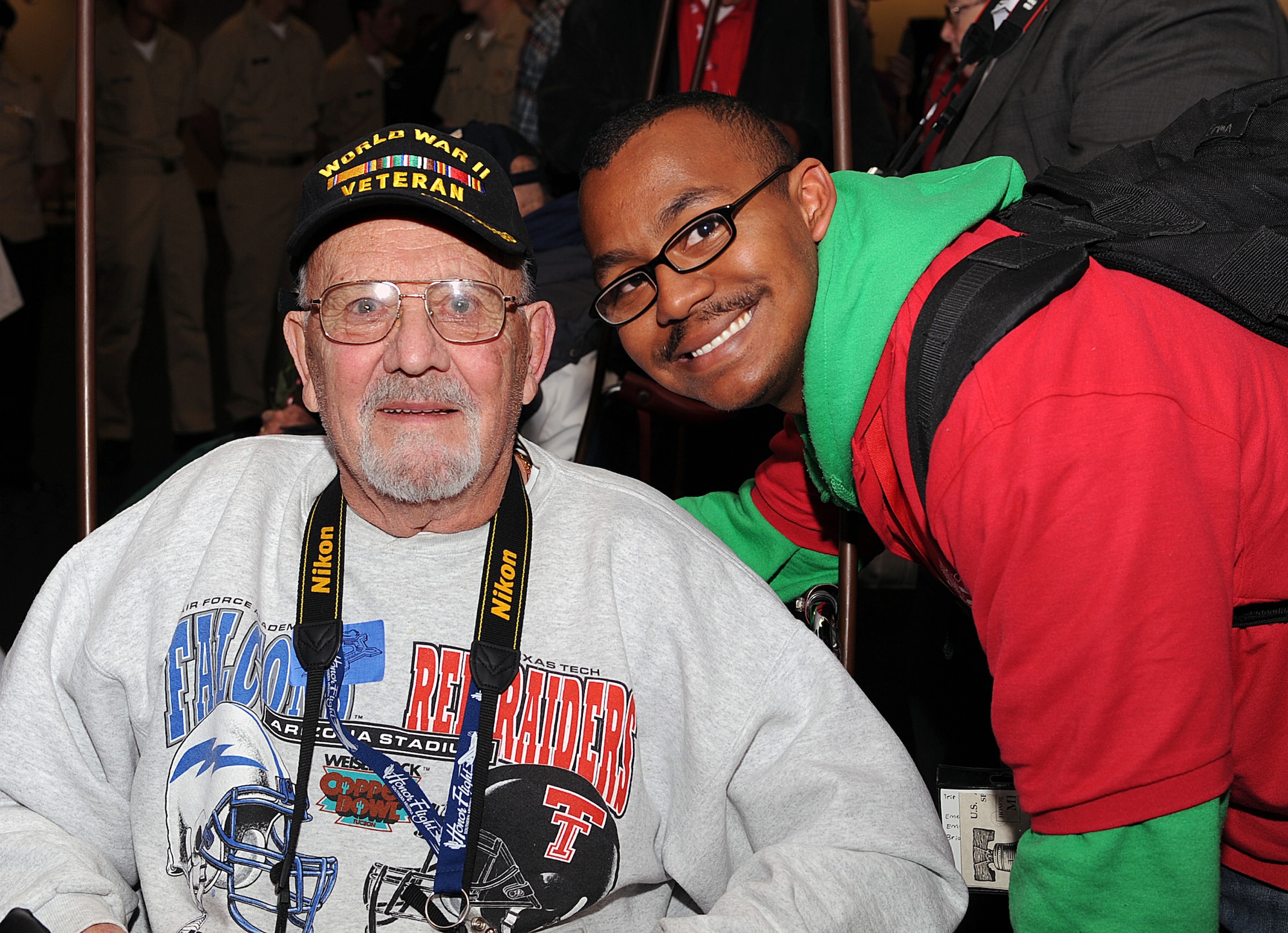 U.S. Air Force retired WWII veteran Mr. Thomas Perrow and U.S. Air Force Senior Airman Sammie Ervan, 355th Logistics Readiness Squadron pose for a photo while being welcomed home at the Tucson International Airport in Tucson, Ariz., March 28, 2013. Both Perrow and Ervan participated in Honor Flight Southern Arizona where they toured national monuments of wars they fought in around the Washington D.C. area. (U.S. Air Force photo by Airman 1st Class Christine Griffiths/Released) 