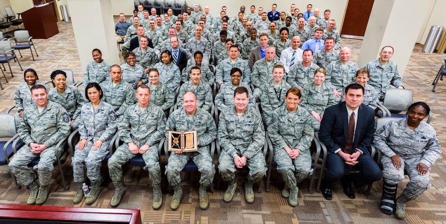 OSI's enlisted Airmen at OSI headquarters gathered to present Brig. Gen. Kevin J. Jacobsen, OSI commander, with an invitation to the Order of the Sword March 29. The general (pictured front, center) proudly displays his official invitation. Jacobsen is the fifth person from OSI to be inducted into the Order of the Sword since the order was established in OSI on June 14, 1985. The Air Force’s Order of the Sword was founded by the enlisted force to recognize and honor military senior officers and civilian equivalents, for significant contributions to the welfare and prestige of the Air Force enlisted corps, mission effectiveness as well as the overall military establishment. 