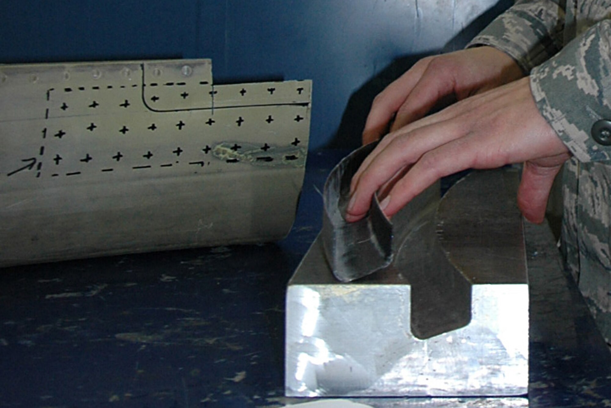 Using a mold developed here, workers in the 446th Maintenance Squadron's structural maintenance flight are able to create a carbon composite fix for repairing cracks in the engine exhaust lip assembly.  (U.S. Air Force photo by Sandra Pishner)
