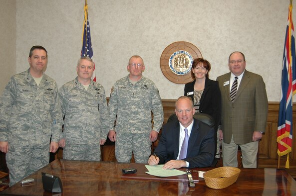 Col. Mike Taheri, 153rd Airlift Wing vice commander; Maj. Gen. Michael Carey, 20th Air Force commander; Army Maj. Gen. Luke Reiner, Wyoming Adjutant General; Pam Ivey, Wyoming Veterans Division executive director; and Larry Barttelbort, Wyoming Veterans Division director, attend Wyo. Gov. Matt Mead’s signing of recent legislation affecting veterans and military families in Mead’s office March 13. (Courtesy photo)