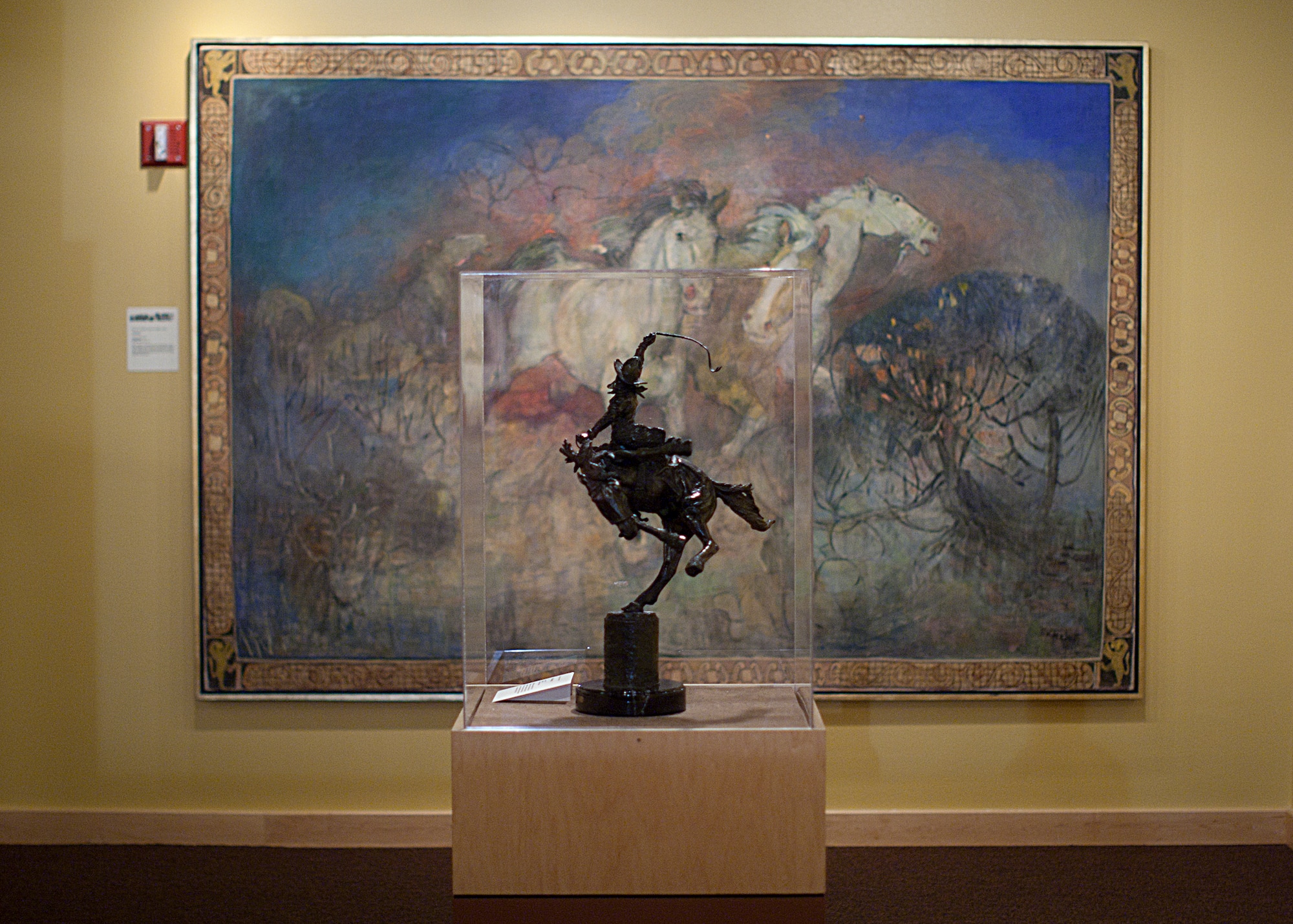 Along with exhibiting historical artifacts from around the state, the Wyoming State Museum also exhibits works of art portraying the multicultural and diverse Wyoming lifestyles. Here "Two Champs," a bronze sculpture by Henry Jackson, sits on display in front of an untitled oil on canvas by Minerva Teichert. (U.S. Air Force photo by Matt Bilden)