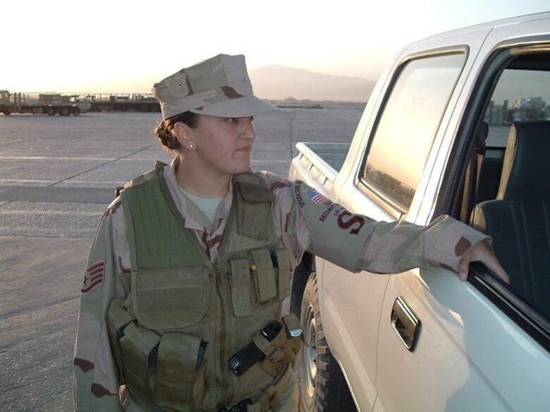 U.S. Air Force Staff Sgt.Marie Garcia, 355th Security Forces Squadron, inspects a vehicle on the flight line during one of her deployments to Bagram Airfield, Afghanistan. Garcia, now a technical sergeant, is the 355th SFS's noncommissioned officer in charge of plans and programs. She is responsible for writing and reviewing the publications and regulations the 355th SFS enforces. (Courtesy photo/Released)