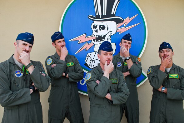FROM LEFT: 2nd Lt. John Patten, Capt. Dakota Olsen, 1st Lt. Jeffrey Whitford, Capt. Pete Sailhamer and 1st Lt. Joseph Valdez, 310th Fighter Squadron student pilots, ponder mustaches March 21 at Luke Air Force Base. The tradition of growing mustaches during March is attributed to Air Force triple-ace Robin Olds who grew an extravagantly waxed handlebar mustache which did not comply with Air Force regulations. (U.S. Air Force photo/Airman 1st Class David Owsianka)