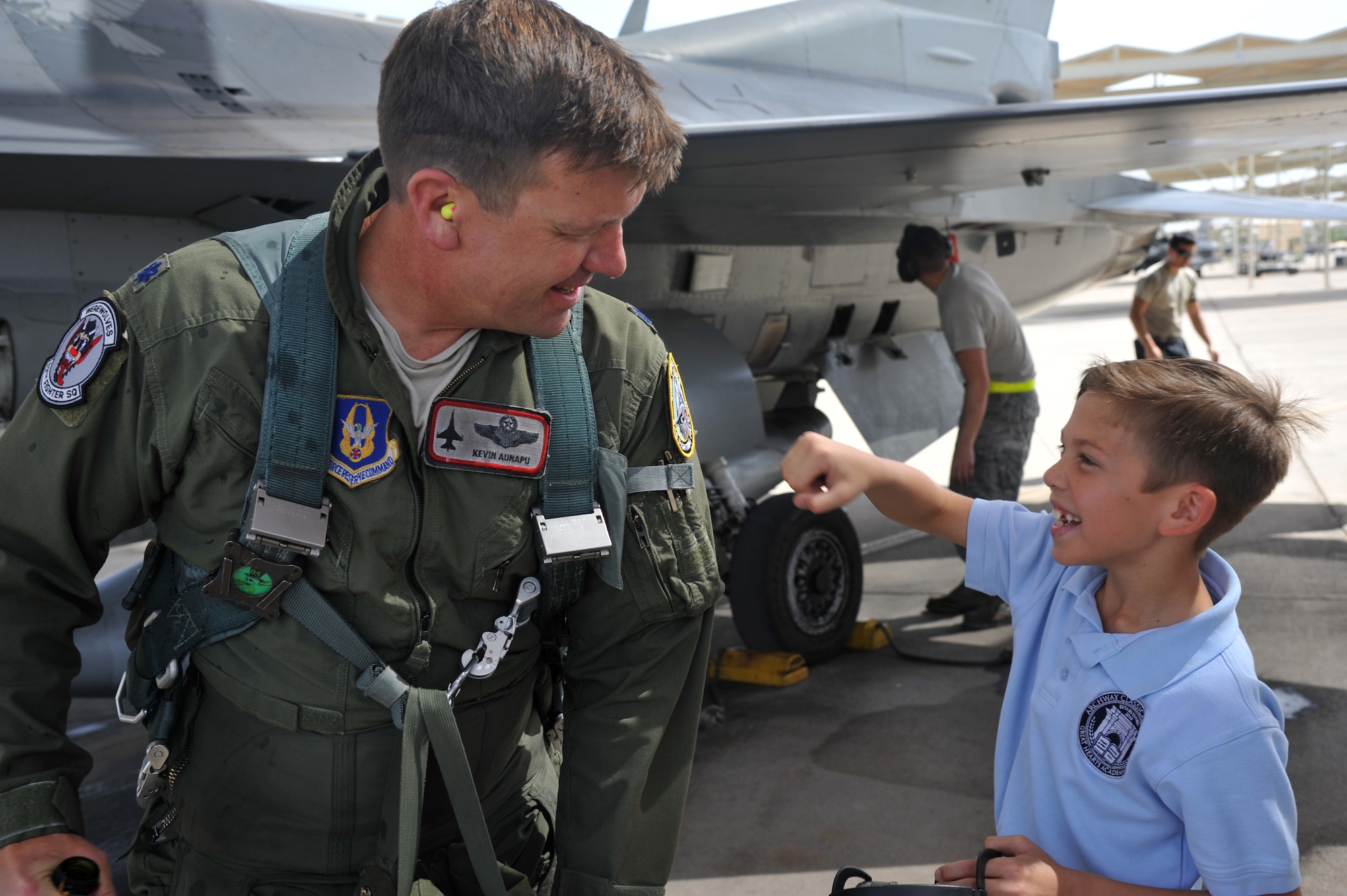 Lt. Col. Kevin Aunapu, 69th Fighter Squadron director of operations, gets a congratulatory punch from his son, after completing his 3,000th flying hour March 21 at Luke Air Force Base. (U.S. Air Force photo/Senior Airman Sandra Welch)
