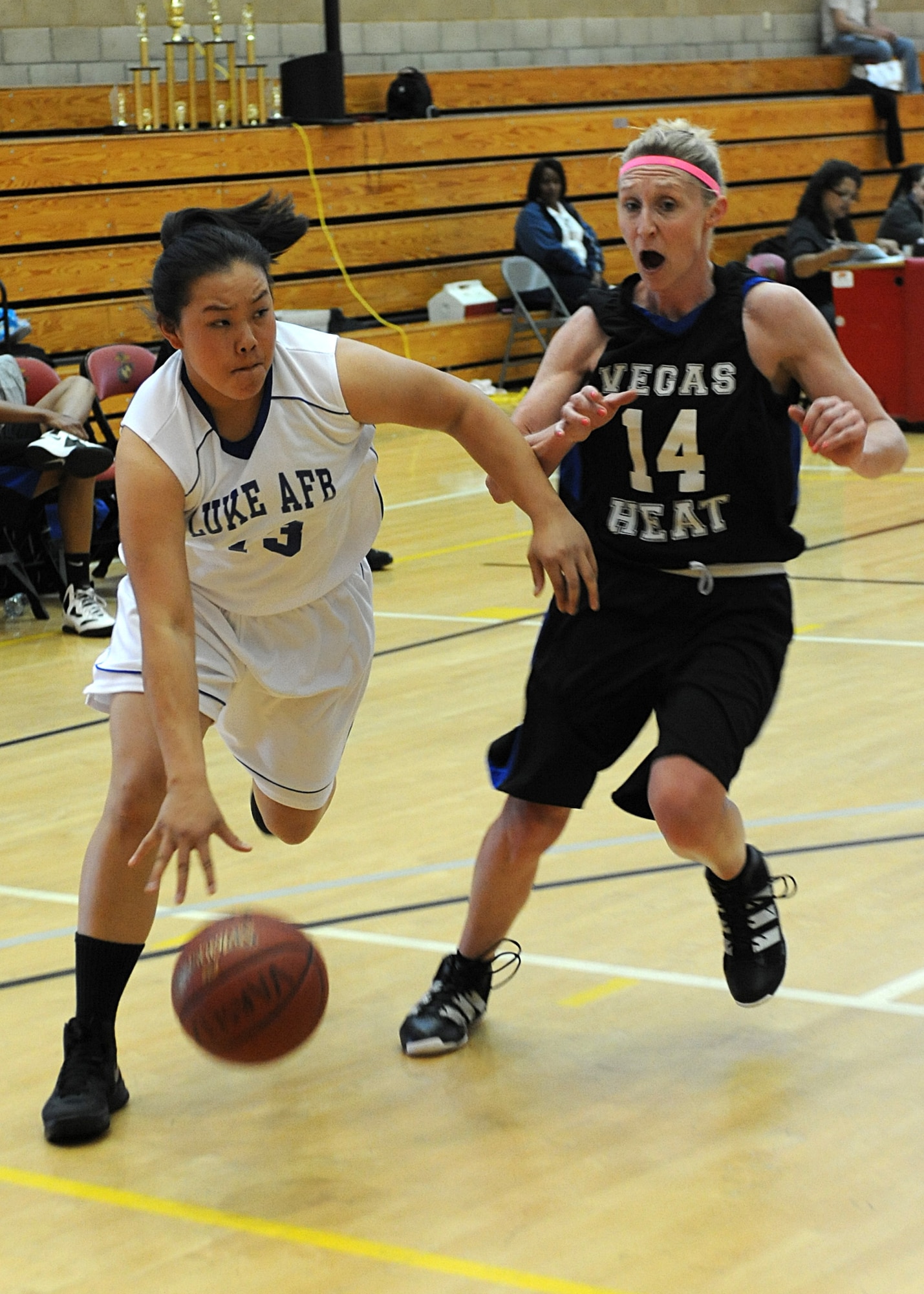 Lady Falcon Pisay Suzuki, 56th Civil Engineer Squadron, avoids a defender during a game against the Vegas Heat March 24 at the Pacific West League Championship Tournament at the Marine Corps Base Camp Pendleton Fitness Center gym.  (U.S. Air Force photo/Airman 1st Class Devante Williams)