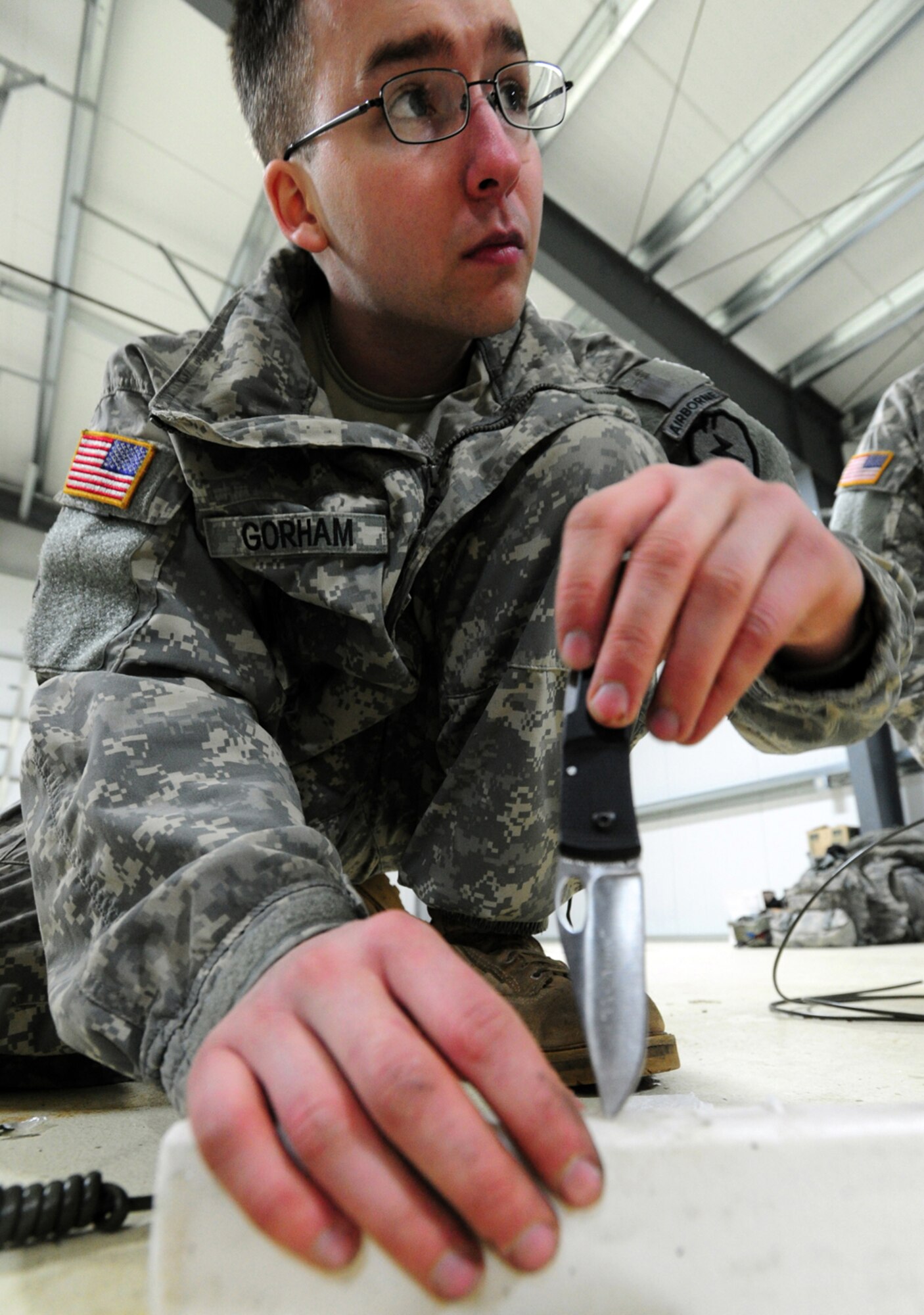 JOINT BASE ELMENDORF-RICHARDSON, Alaska -- Pfc. Keith Gorham, a native of Buxton, Maine, cuts a block of C-4 before a demolitions exercise. Soldiers assigned to A Company, 425th Brigade Special Troops Battalion, rigged trees with C-4 plastic explosive during a training exercise at Forward Operating Base Sparta on Joint Base Elmendorf-Richardson, March 21, 2013. The exercise allowed the Soldiers to train with demolitions and taking down trees to block enemy advance on roadways. (U.S. Air Force photo/Justin Connaher)