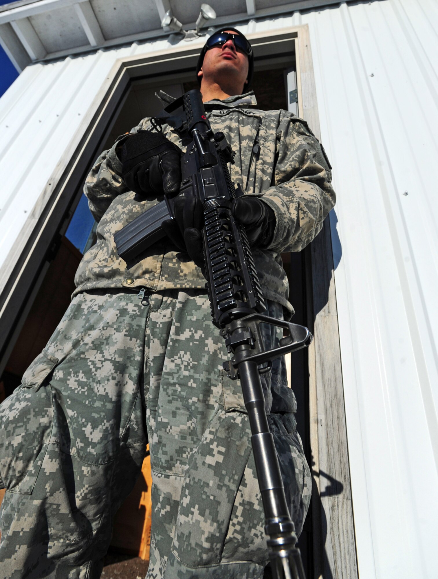 JOINT BASE ELMENDORF-RICHARDSON, Alaska -- Pfc. Rafael Rivera, a native of Coamo, Puerto Rico, guards explosives before a demolitions exercise. Soldiers assigned to A Company, 425th Brigade Special Troops Battalion, rigged trees with C-4 plastic explosive during a training exercise at Forward Operating Base Sparta on Joint Base Elmendorf-Richardson, March 21, 2013. The exercise allowed the Soldiers to train with demolitions and taking down trees to block enemy advance on roadways. (U.S. Air Force photo/Justin Connaher)