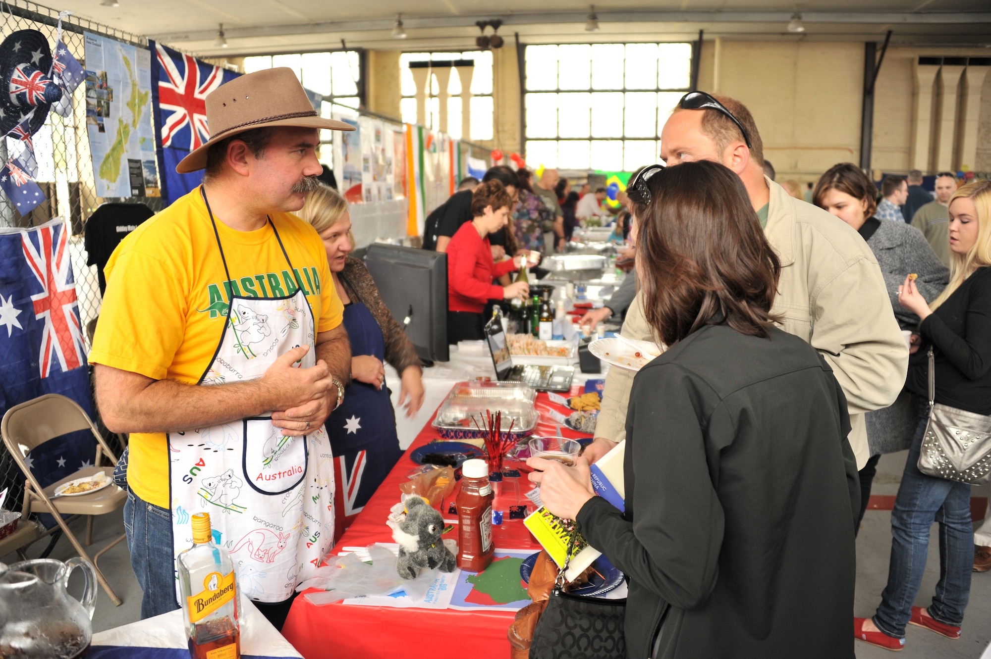 Air War College student Lt. Col. Andrew Gilbert, Australia, offers kangaroo sausage to visitors at his booth at the AWC International Fellows Cultural Festival, held on Maxwell Air Force Base, March 23. (U.S. Air Force photo by Senior Airman Christopher Stoltz)
