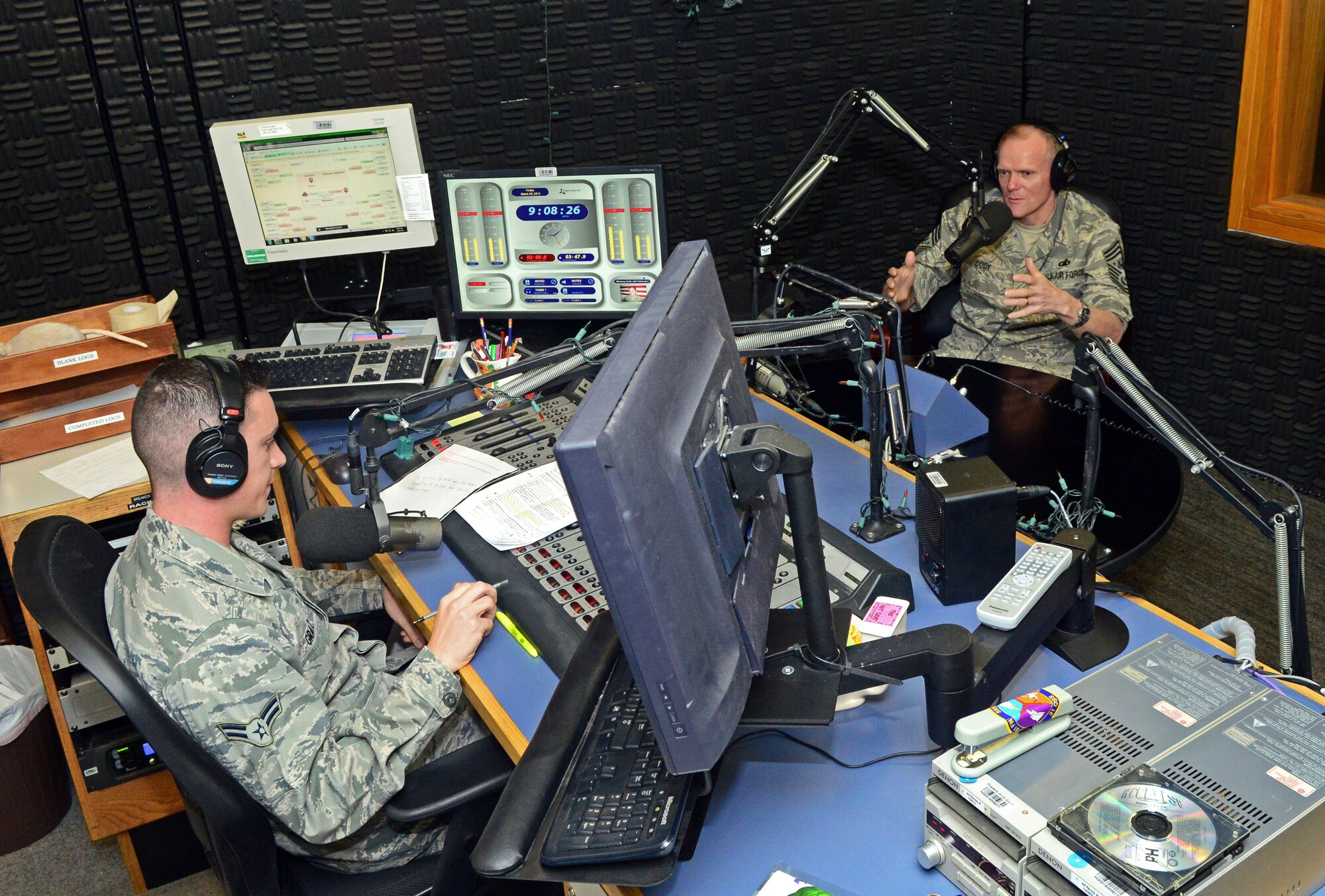 Chief Master Sgt. of the Air Force James Cody talks on the air to Airman 1st Class Brian Gratz, Detachment 8 Armed Forces Network radio DJ, at Aviano Air Base, Italy, Mar. 29, 2013. Cody spoke about his visit to the 31st Fighter Wing and gave a special shout out to all the military spouses for their dedication and support to their families. (U.S. Air Force photo/Airman 1st Class Matthew Lotz)