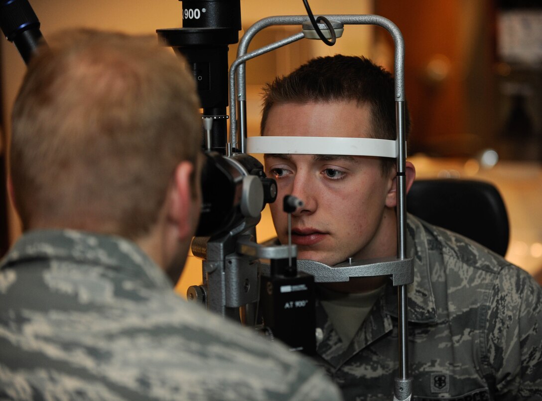 Airman 1st Class Charles Wood, 28th Medical Operations Squadron, has his eyes examined during a health evaluation at Ellsworth Air Force Base, S.D., March 15, 2013. A bio-microscope is used to determine the health of the eye’s interior and posterior walls. (U.S. Air Force photo by Airman 1st Class Zachary Hada/Released)
