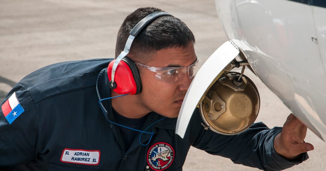 Adrian Ramirez, 47th Maintenance Directorate aircraft attendant, performs a pre-flight inspection on a T-1A Jayhawk at Laughlin Air Force Base, Texas, March 20, 2013. Pre-flight inspections are performed on Laughlin’s aircraft before each flight.(U.S. Air Force photo by Airman 1st Class John D. Partlow)