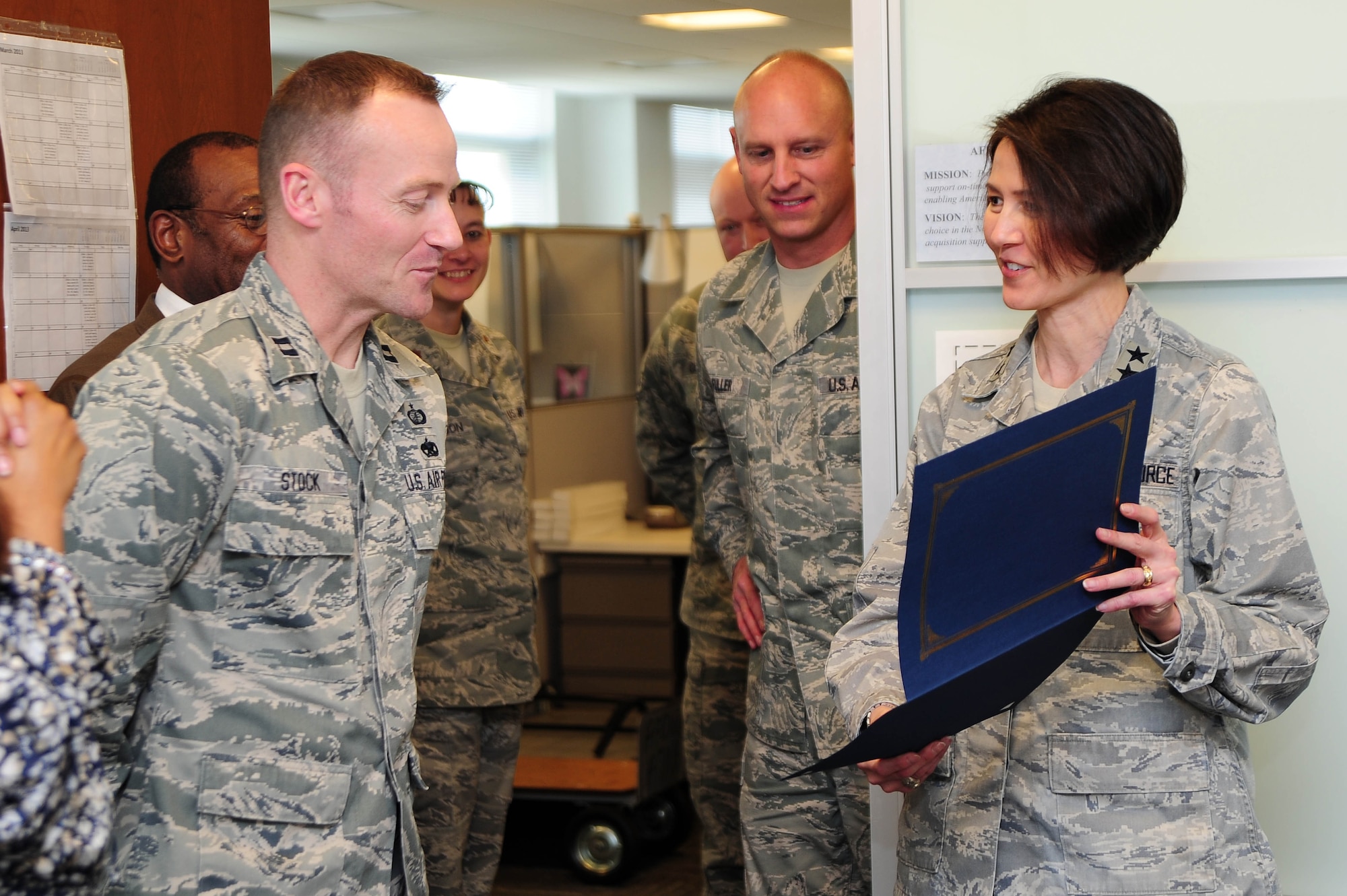 Air Force District of Washington Commander Maj. Gen. Sharon K. G. Dunbar presents Capt. Brandon Stock, Headquarters AFDW Contracting, with a certificate of selection for promotion to the rank of major, March 27, 2013, at Joint Base Andrews, Md. Five officers were selected for promotion to major within HQ AFDW staff. (U.S. Air Force photo by Senior Airman Steele C. G. Britton)