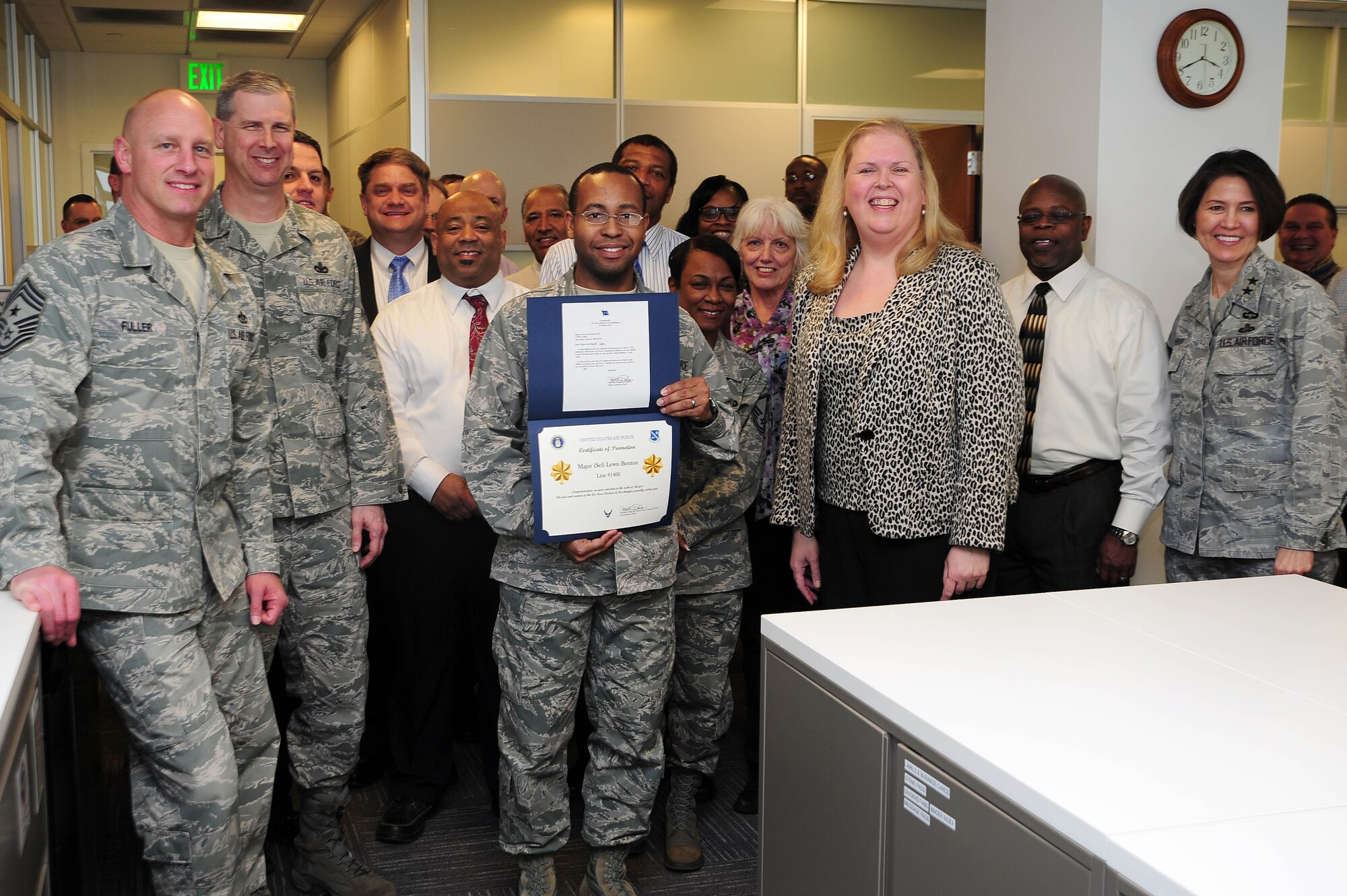 Air Force District of Washington Commander Maj. Gen. Sharon K. G. Dunbar and fellow Headquarters AFDW leadership and staff congratulate Capt. Lewis Benton, HQ AFDW Logistics, upon being selected for promotion to the rank of major, March 27, 2013, at Joint Base Andrews, Md. ?I was surprised and humbled, Benton said. ?It truly felt good to celebrate with my AFDW family.? (U.S Air Force photo by Senior Airman Steele C. G. Britton)