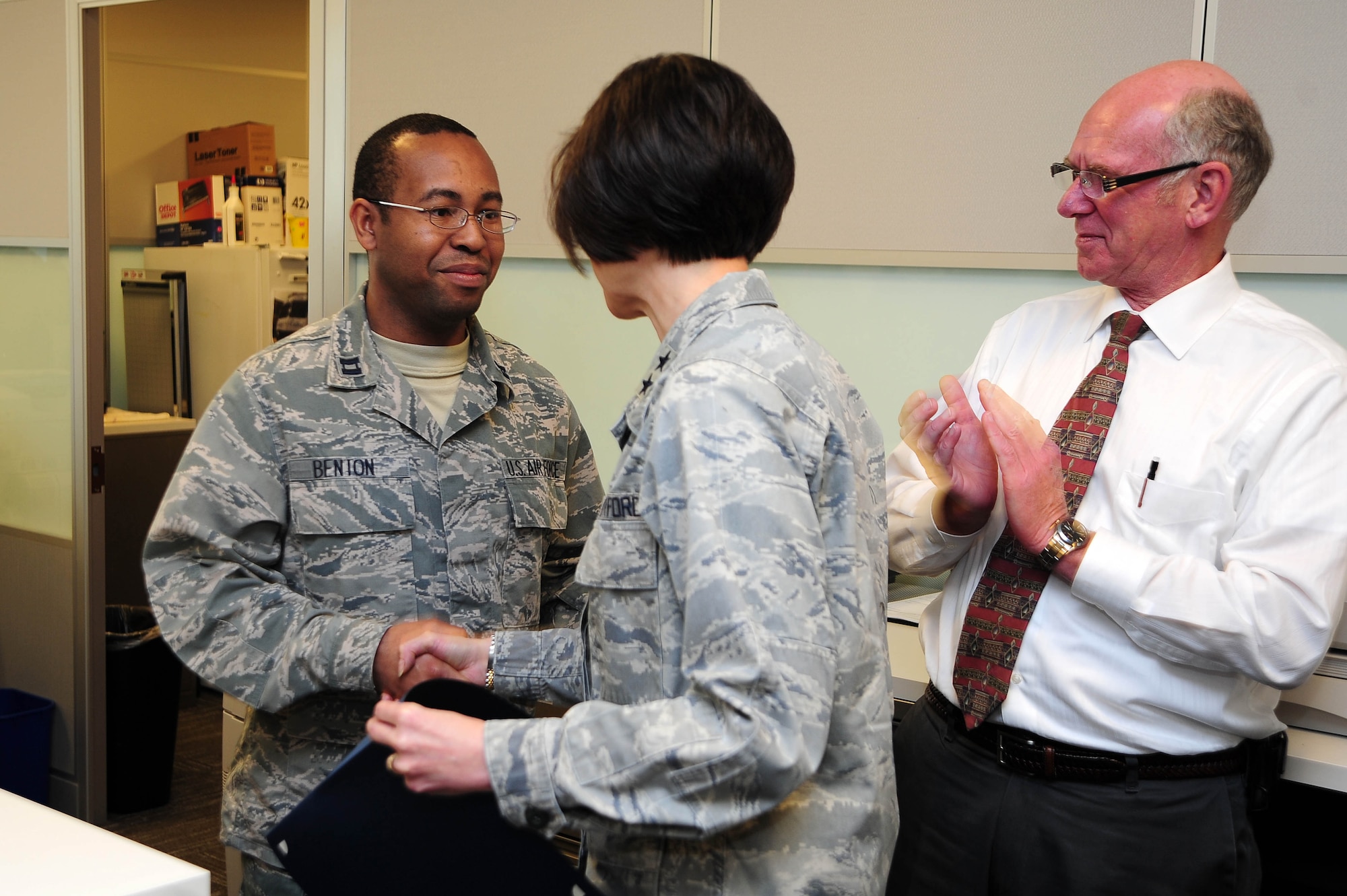 Air Force District of Washington Commander Maj. Gen. Sharon K. G. Dunbar presents Capt. Lewis Benton III, Headquarters AFDW Logistics, with a certificate of selection for promotion to the rank of major, March 27, 2013, at Joint Base Andrews, Md. Five officers were selected for promotion to major within HQ AFDW staff. (U.S. Air Force photo by Senior Airman Steele C. G. Britton)
