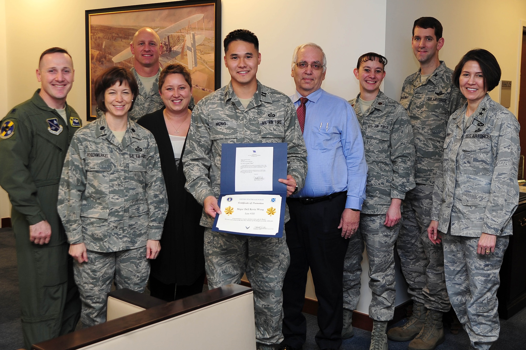 Air Force District of Washington Commander Maj. Gen. Sharon K. G. Dunbar and fellow Headquarters AFDW leadership and staff congratulate Capt. Kevin Wong, HQ AFDW Intelligence, upon being selected for promotion to the rank of major, March 27, 2013, at Joint Base Andrews, Md. ?I feel honored that the Air Force is entrusting me with a new level of responsibility,? Wong said. ?I'm looking forward to managing new challenges.? (U.S Air Force photo by Senior Airman Steele C. G. Britton) 
