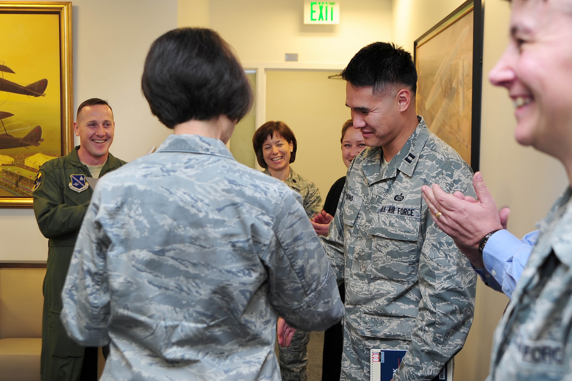 Air Force District of Washington Commander Maj. Gen. Sharon K. G. Dunbar presents Capt. Kevin Wong, Headquarters AFDW Intelligence, with a certificate of selection for promotion to the rank of major, March 27, 2013, at Joint Base Andrews, Md. Five officers were selected for promotion to major within HQ AFDW staff. (U.S. Air Force photo by Senior Airman Steele C. G. Britton)