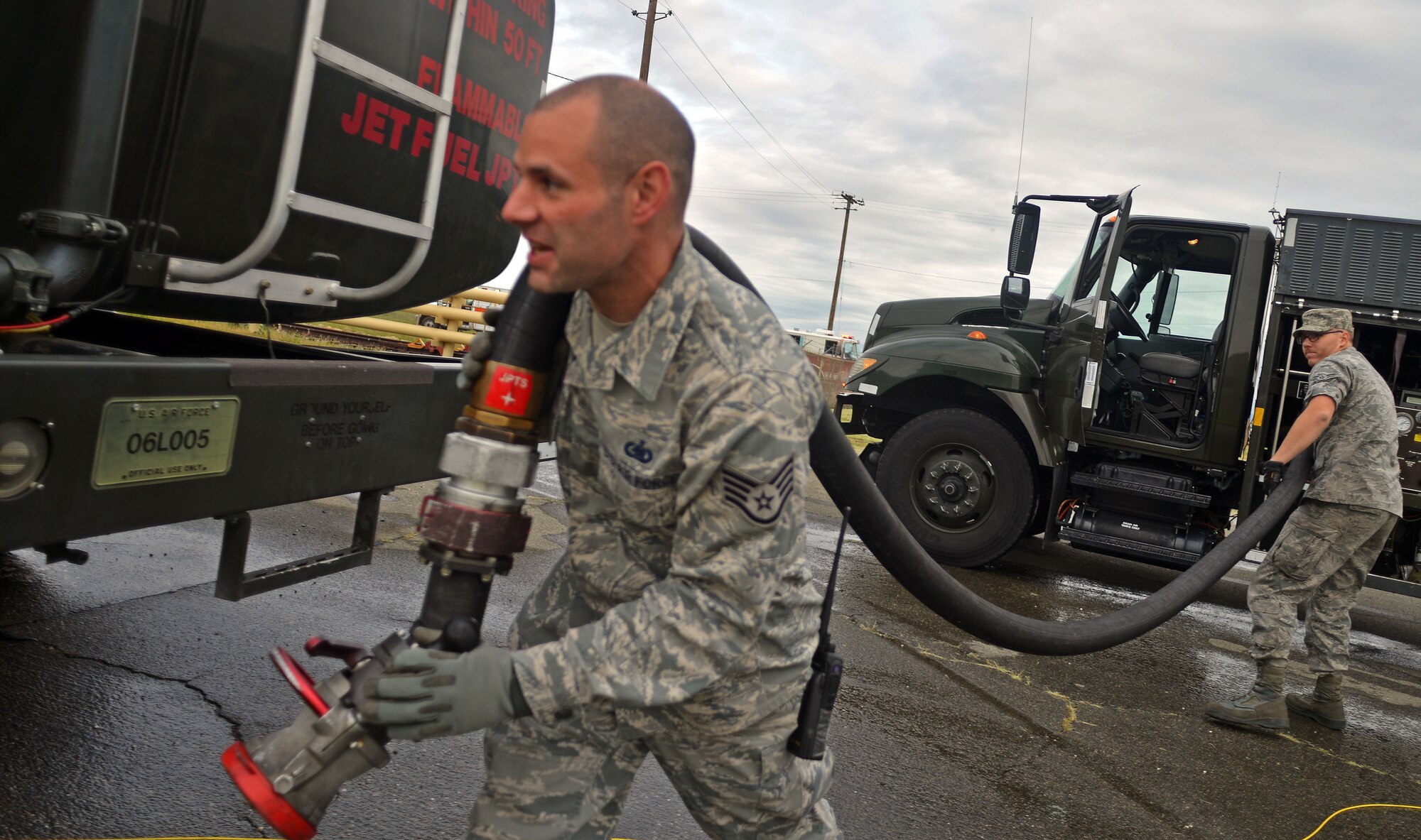 Staff Sgt. Christopher Pragoff and Airman 1st Class Trevor Story, 9th Logistics Readiness Squadron fuels distribution operators, work to contain a simulated JPTS fuel spill on Beale Air Force Base, Calif., March 28, 2013. The exercise demonstrated the response efforts of Team Beale personnel. (U.S. Air Force photo by Airman 1st Class Drew Buchanan/Released)