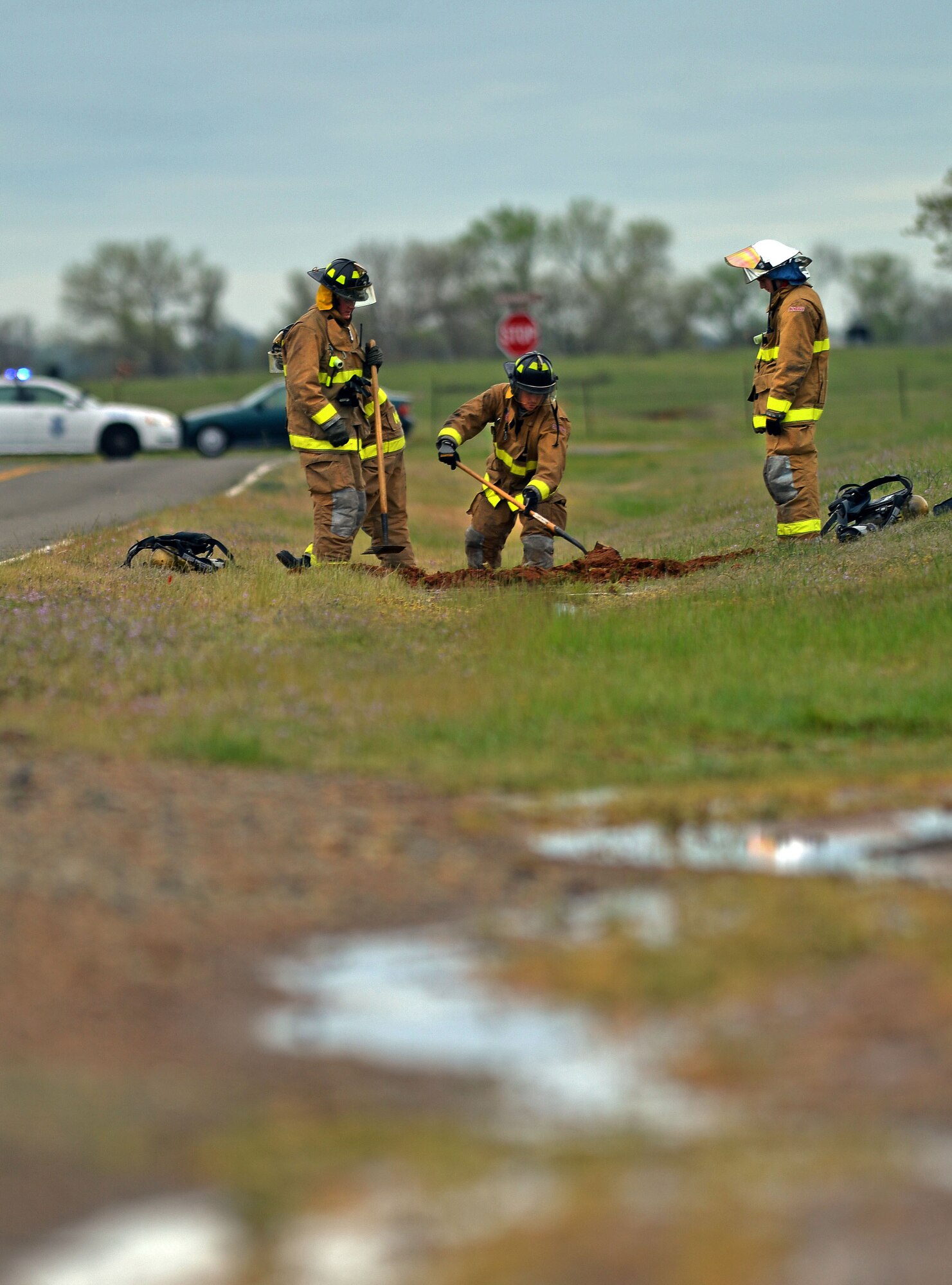 Firefighters from the 9th Civil Engineering Squadron construct a temporary dam to contain a simulated JPTS fuel spill on Beale Air Force Base, Calif., March 28, 2013. The exercise helps to familiarize Team Beale personnel on how to handle a major fuel spill. (U.S. Air Force photo by Airman 1st Class Drew Buchanan/Released)
