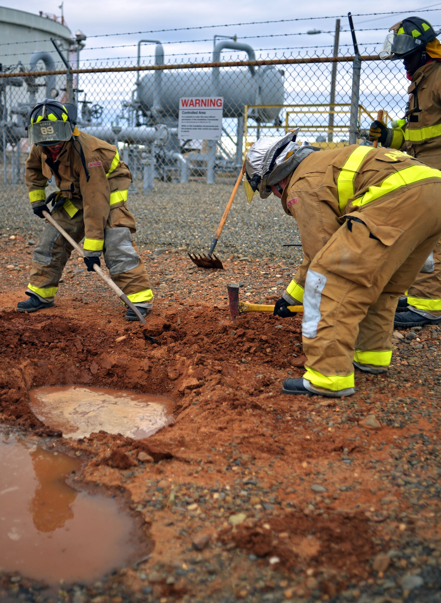 Firefighters from the 9th Civil Engineering Squadron work to contain a simulated JPTS fuel spill on Beale Air Force Base, Calif., March 28, 2013. (U.S. Air Force photo by Airman 1st Class Drew Buchanan/Released)