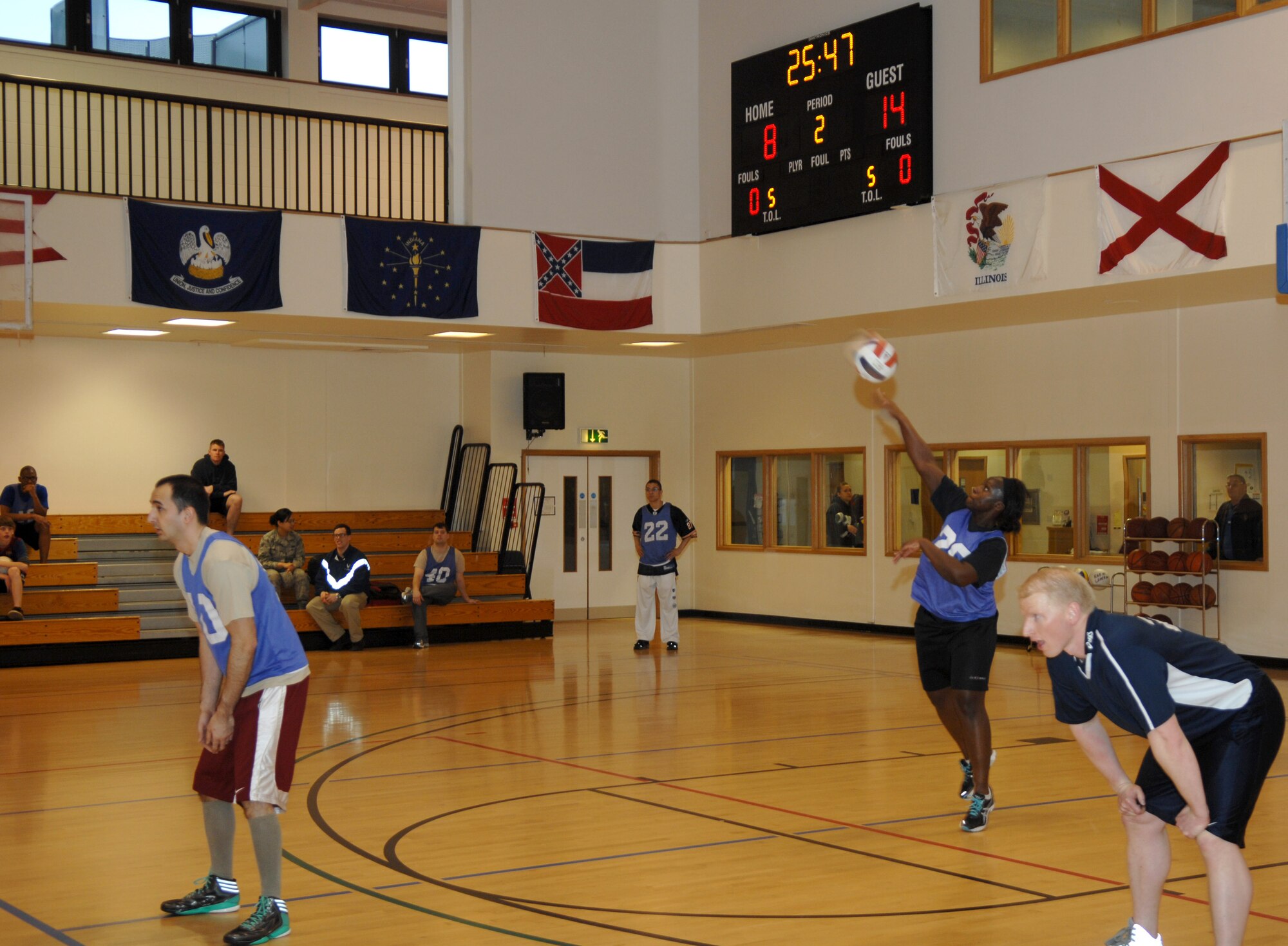 Second from right, Tech. Sgt. Christine Johnson, 95th Reconnaissance Squadron NCO in charge of intelligence operations from Miami, Fla., serves the ball during an intramural volleyball game against the 100th Operations Group March 28, 2013, at the Hardstand Fitness Center on RAF Mildenhall, England. The 100th OG was victorious over the 95th RS in both matches. (U.S. Air Force photo by Airman 1st Class Dillon Johnston/Released)