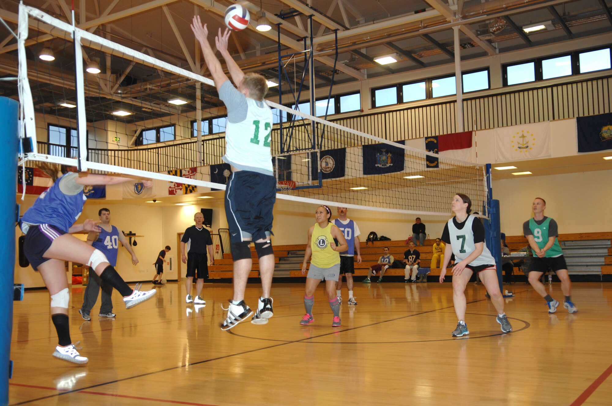 Maj. Joshua Hiam, 100th Air Refueling Wing Plans and Programs chief of plans from Lancaster Pa., jumps to block a shot during an intramural volleyball game between the 100th Operations Group and 95th Reconnaissance Squadron March 28, 2013, at the Hardstand Fitness Center on RAF Mildenhall, England. The 100th OG was victorious over the 95th RS in both matches. (U.S. Air Force photo by Airman 1st Class Dillon Johnston/Released)