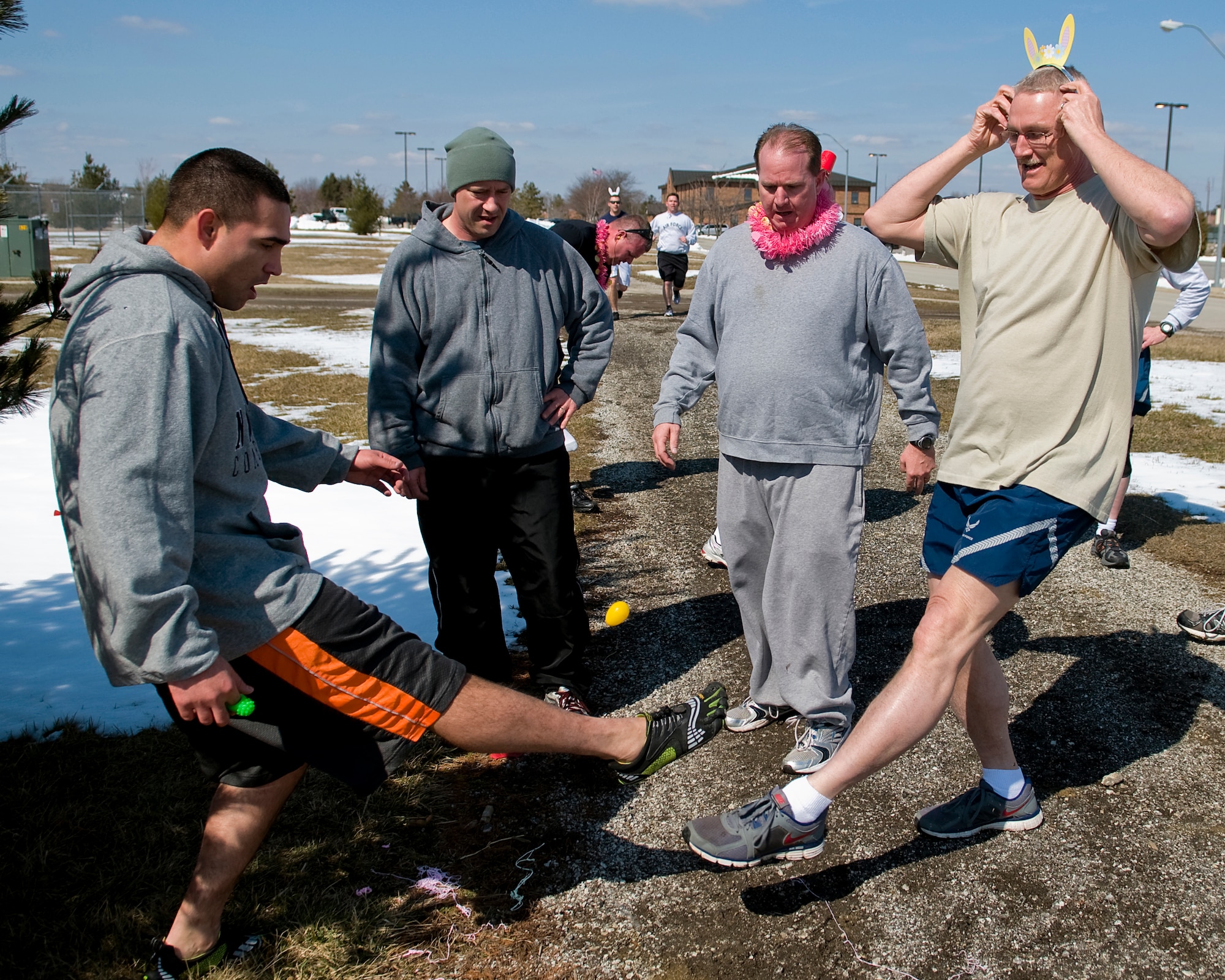 GRISSOM AIR RESERVE BASE, Ind. -- Lamar Woods, Shane Taylor, Corey Maston and Tim Wood play a version of hacky sack with a plastic Easter egg during an Easter egg fun run held here March 28. Teams had to stop at multiple stations during the three-mile run and complete holiday-themed tasks. (U.S. Air Force photo/Tech. Sgt. Mark R. W. Orders-Woempner)
