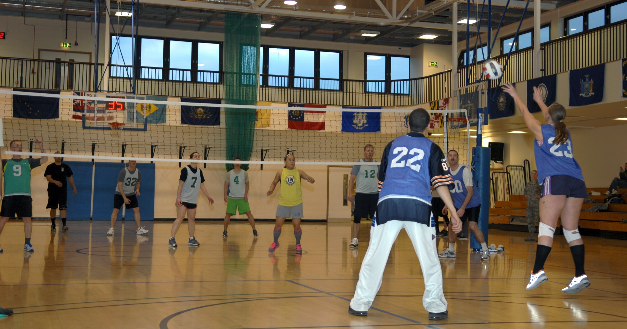 From right, Staff Sgt. Chantel Green, Detachment 2 25th Intelligence Squadron direct support operator from Fort Walton Beach, Fla., sets up the ball for a spike during an intramural volleyball game between the 100th Operations Group and 95th Reconnaissance Squadron March 28, 2013, at the Hardstand Fitness Center on RAF Mildenhall, England. The 100th OG was victorious over the 95th RS in both matches. (U.S. Air Force photo by Airman 1st Class Dillon Johnston/Released)