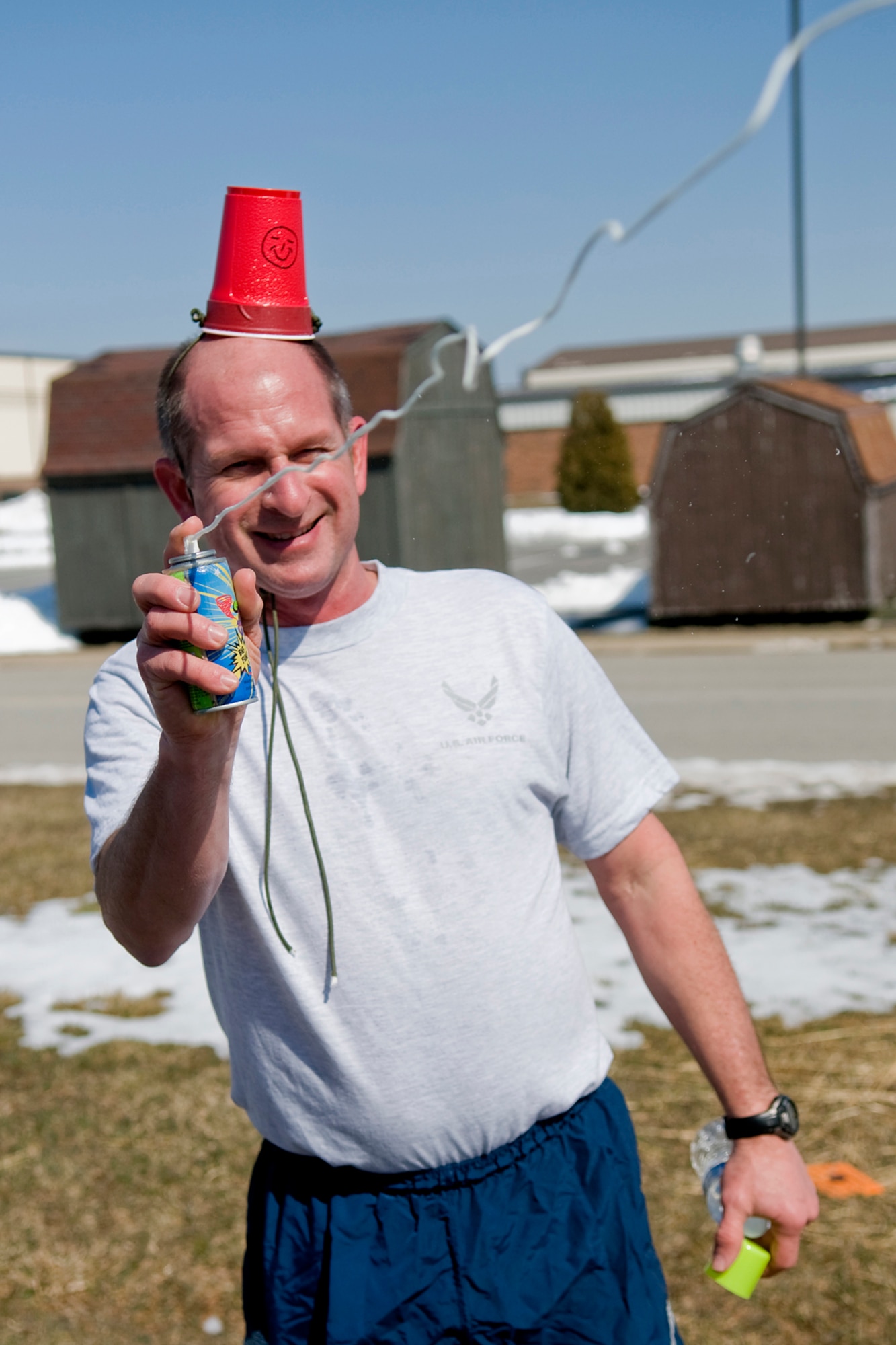 GRISSOM AIR RESERVE BASE, Ind. -- Steven Burton shoots aerosol string at one of his teammates during  an Easter egg fun run held here March. 28. Teams had to stop at multiple stations during the three-mile run and complete holiday-themed tasks. (U.S. Air Force photo/Tech. Sgt. Mark R. W. Orders-Woempner)