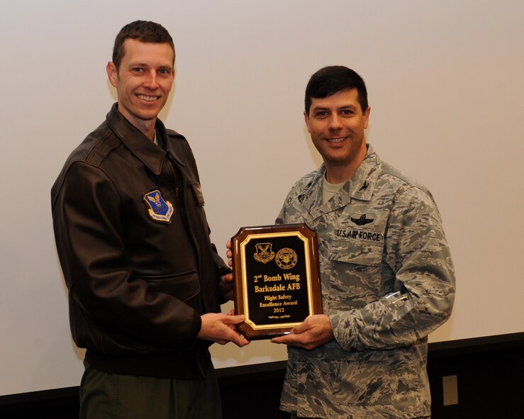Capt. Mark Hryhorchuk, 2nd Bomb Wing Safety, receives the Air Force Global Strike Command Flight Safety Excellence Award for 2012 from Col. Andrew Gebara, 2 BW commander, on Barksdale Air Force Base, La., March 27. (U.S. Air Force photo/Airman 1st Class Benjamin Gonsier)
