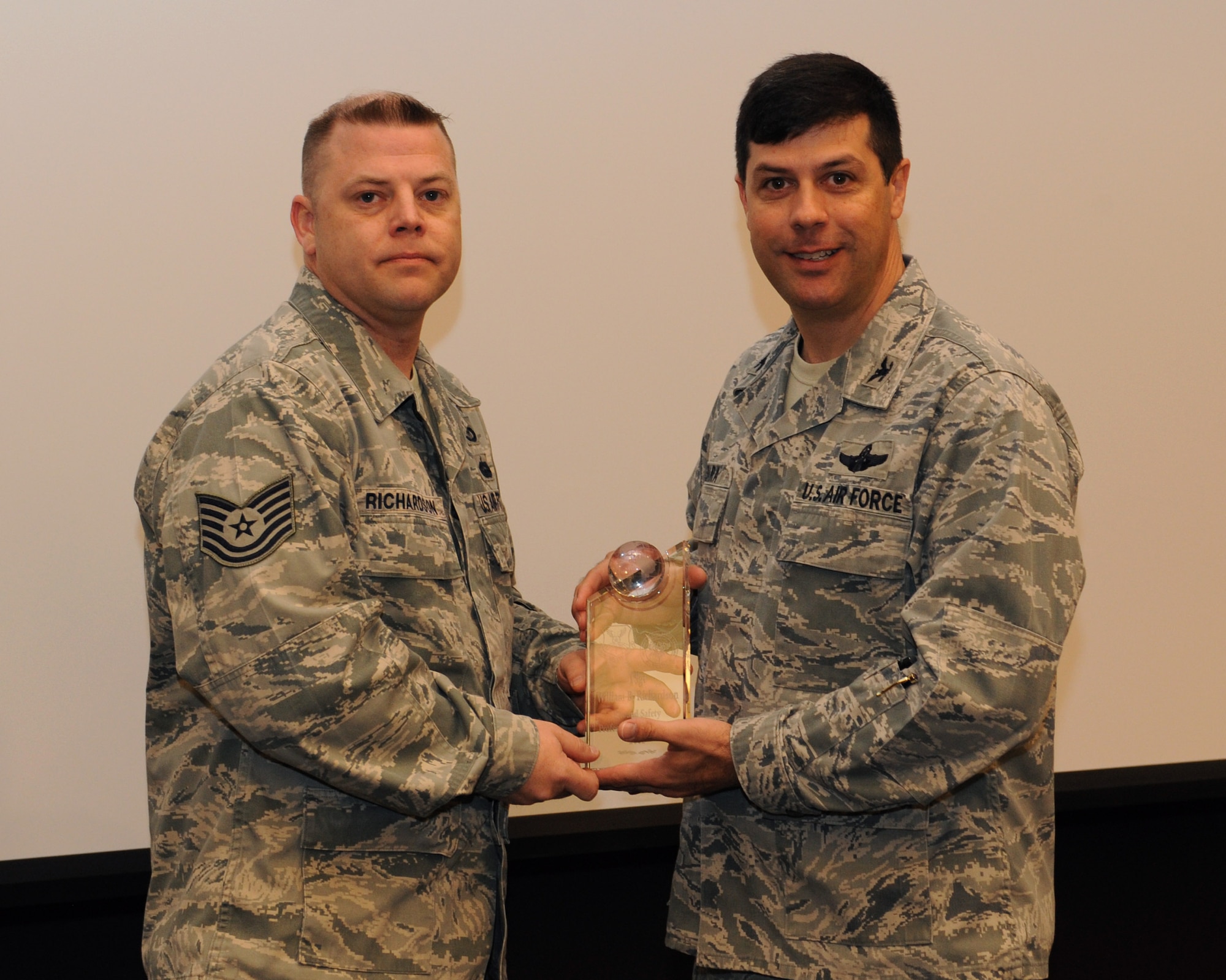 Tech. Sgt. William Richardson, 2nd Bomb Wing Safety, receives the Air Force Global Strike Command Ground Safety Professional of the Year Award for 2012 from Col. Andrew Gebara, 2 BW commander, on Barksdale Air Force Base, La., March 27. (U.S. Air Force photo/Airman 1st Class Benjamin Gonsier)