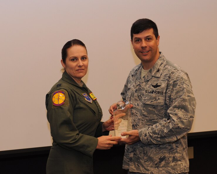 Capt. Kasey Moore-Ritchie, 2nd Aerospace Medicine Squadron, receives the Air Force Global Strike Command Human Factors Safety Award for 2012 from Col. Andrew Gebara, 2nd Bomb Wing commander, on Barksdale Air Force Base, La., March 27. (U.S. Air Force photo/Airman 1st Class Benjamin Gonsier)