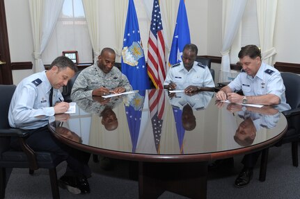 (From left) Col. Gerald V. Goodfellow, 12th Flying Training Wing commander, Maj. Gen. A.J. Stewart, Air Force Personnel Center commander, Gen. Edward A. Rice Jr., commander of Air Education and Training Command, and Brig. Gen. John P. Horner, Air Force Recruiting Service commander, sign their pledge form for Air Force Assistance Fund in General Rice's office at Joint Base San Antonio-Randolph, Texas, March 26, 2013. (U.S. Air Force photo/Joel Martinez)
