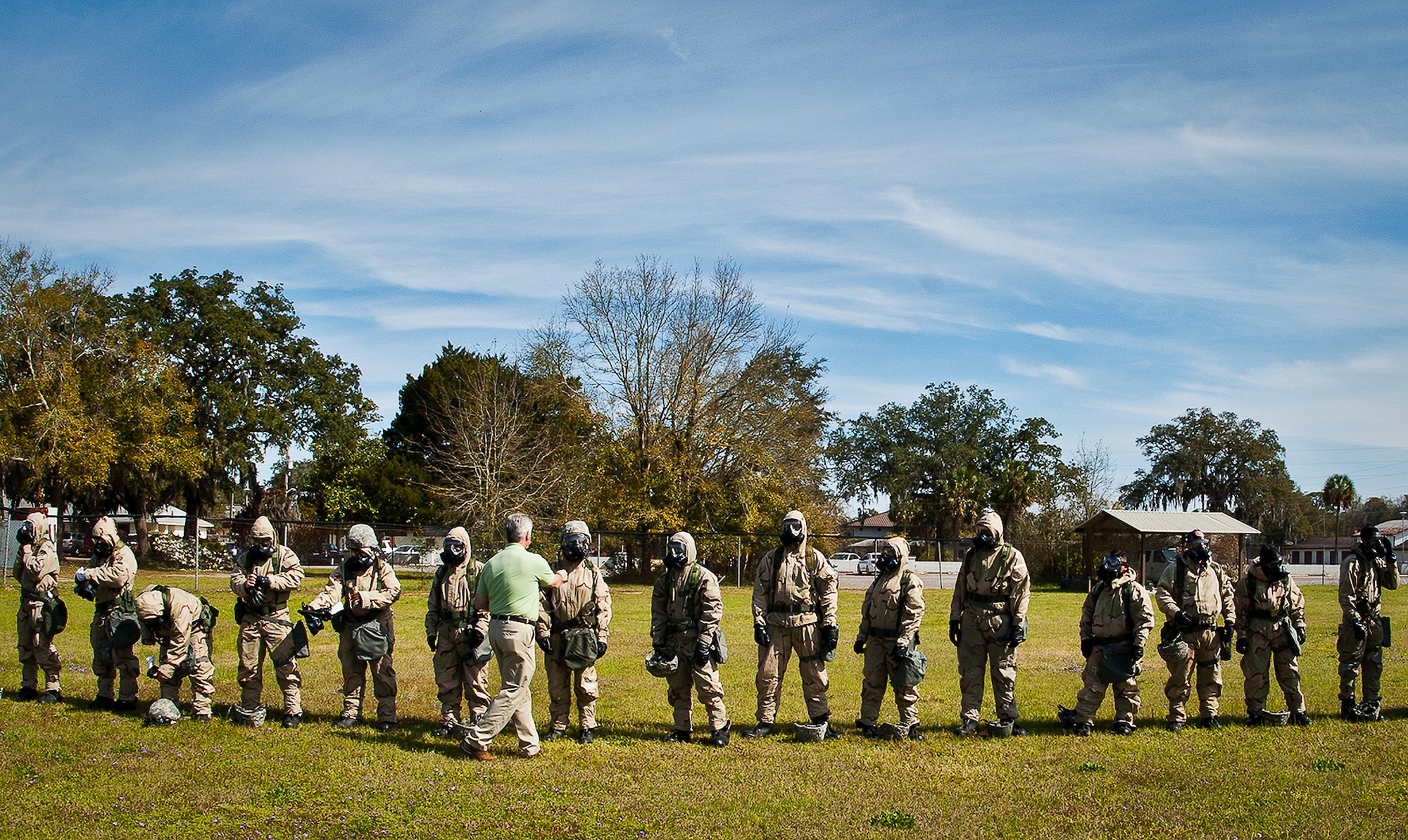 Michael Crow, a contractor with the Emergency Management Flight Support waves a smelling agent around Airman’s gas mask to ensure they fit and are sealed properly during the field training portion of a Phase II exercise March 21 at Eglin Air Force Base, Fla. A Phase II evaluates a unit's ability to meet wartime and contingency taskings of employing the force, sustaining the force and the ability to survive and operate.  More than 75 deployers, in two groups, received classroom and practical field training over March 20-21 to meet the readiness requirement.  (U.S. Air Force photo/Samuel King Jr.) 