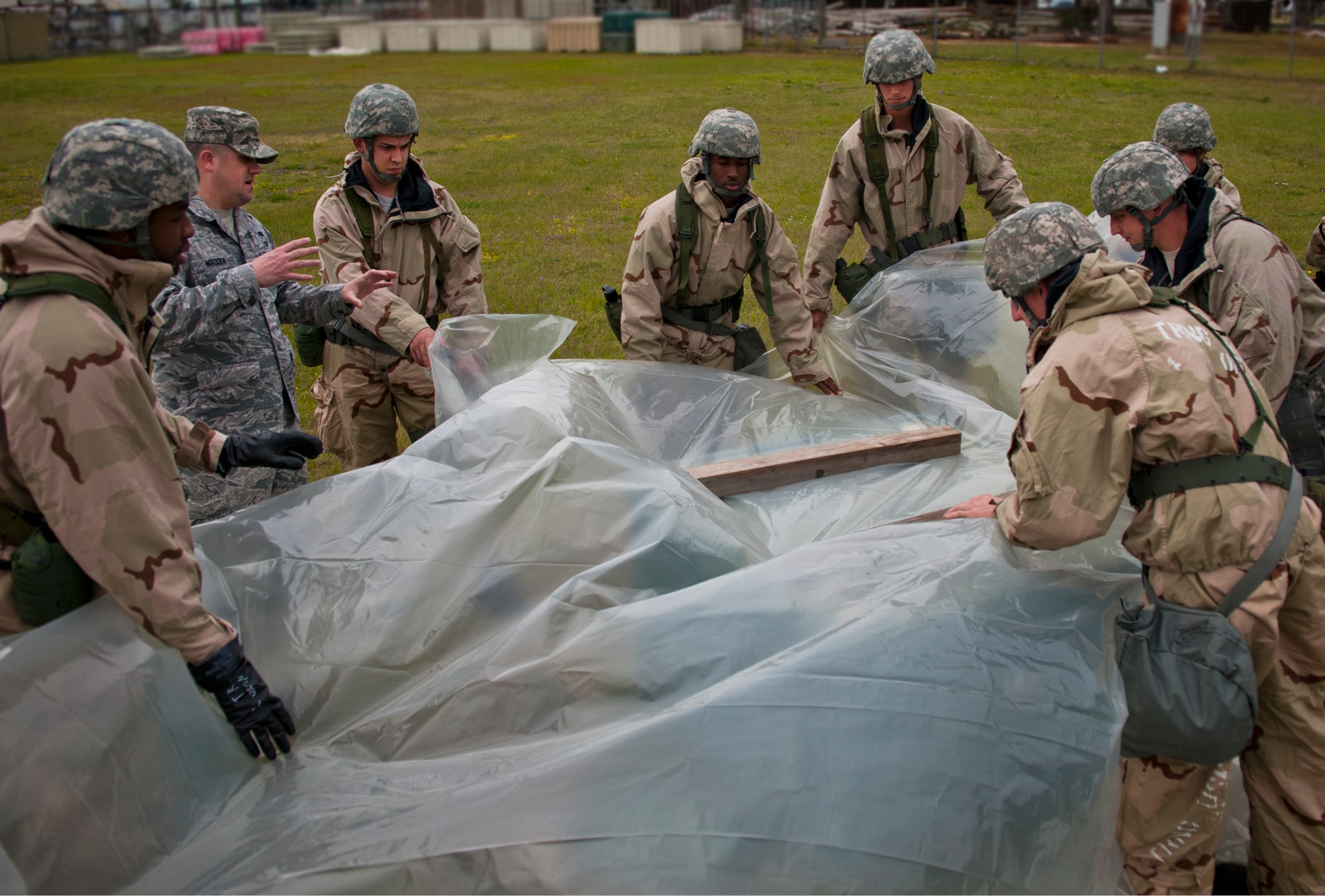Airmen learn to cover a valuable asset as part of contamination avoidance measures during the field training portion of a Phase II exercise March 20 at Eglin Air Force Base, Fla. A Phase II evaluates a unit's ability to meet wartime and contingency taskings of employing the force, sustaining the force and the ability to survive and operate.  More than 75 deployers, in two groups, received classroom and practical field training over March 20-21 to meet the readiness requirement.  (U.S. Air Force photo/Samuel King Jr.)