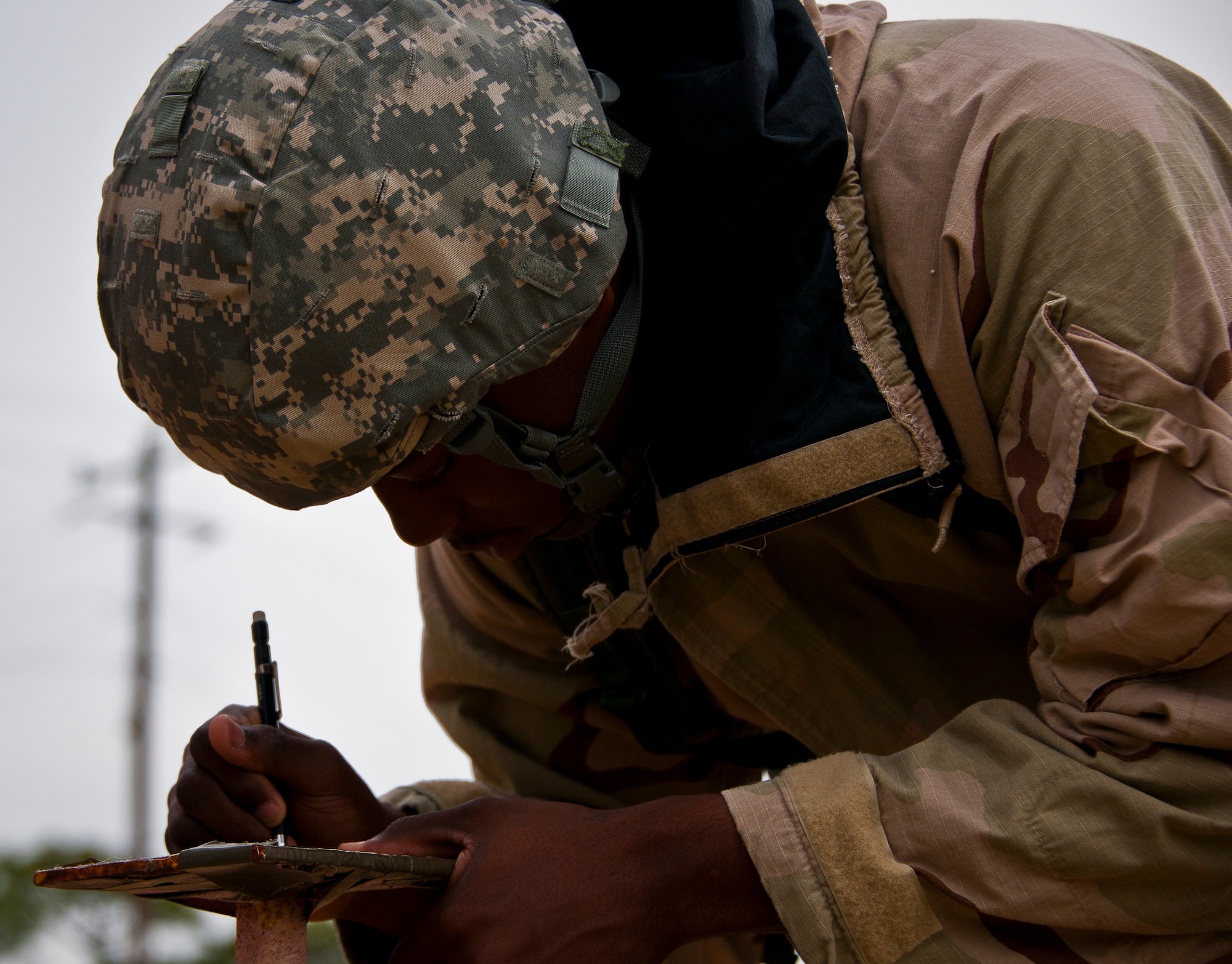 An Airman annotates the date on M8 contamination paper during the field training portion of a Phase II exercise March 20 at Eglin Air Force Base, Fla. A Phase II evaluates a unit's ability to meet wartime and contingency taskings of employing the force, sustaining the force and the ability to survive and operate.  More than 75 deployers, in two groups, received classroom and practical field training over March 20-21 to meet the readiness requirement.  (U.S. Air Force photo/Samuel King Jr.)