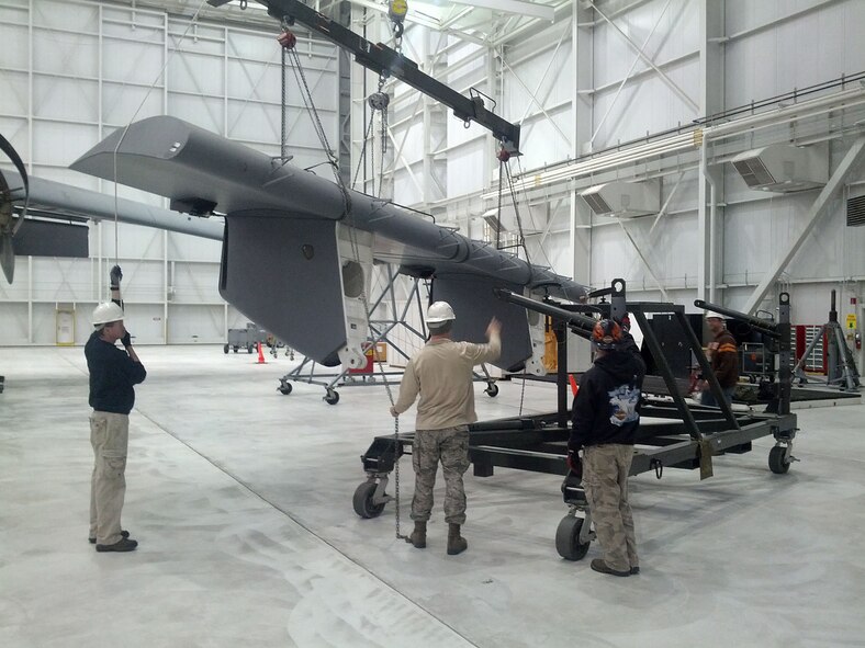 WRIGHT-PATTERSON AIR FORCE BASE, Ohio - Airmen from both 445th Maintenance and 445th Aircraft Maintenance Squadrons work together during a Home Station Check Inspection Feb. 26 to replace the inboard flap that incurred weather damage. (Courtesy photo)  